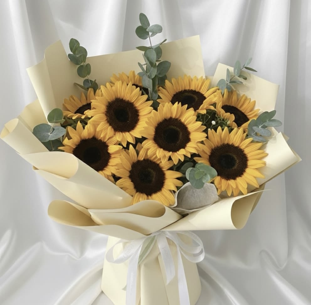 Sunflower Bouquet – 5, 12 or 20 - Brighten someone’s day with our beautiful Sunflower Bouquet, a fresh and joyful arrangement designed to bring warmth, positivity, and natural charm.  This handcrafted bouquet features vibrant, premium sunflowers arranged in a soft and elegant wrapping style. Its cheerful and radiant appearance makes it perfect for birthdays, congratulations, get-well wishes, celebrations, or simply to make someone smile.  Available in three size options:  • 5 Sunflowers – A sweet and thoughtful gesture • 10 Sunflowers – A fuller and more eye-catching bouquet • 15 Sunflowers – A bold and vibrant floral statement  Accent greenery and wrapping style may vary based on seasonal availability to ensure freshness and overall design quality.  Handcrafted by AMORE in Nashville, Tennessee. Available for local flower delivery in Nashville and surrounding areas. Same-day delivery available based on schedule.