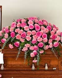 Pink Serenity Spray - A vibrant and heartfelt casket spray featuring striking hot pink roses and soft pink carnations, accented with lush fresh greens. This classic design offers a warm and loving tribute, combining elegance, color, and simplicity to honor a cherished life.