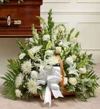 Pure Serenity Sympathy Basket - A serene and elegant white sympathy floral basket featuring a harmonious mix of white snapdragons, white spider mums, white roses, white carnations, white lilies, and white asters, beautifully accented with fresh greenery.  Finished with a white ribbon bow, this timeless arrangement symbolizes peace, purity, and heartfelt remembrance, offering a dignified and comforting tribute for honoring a cherished life.