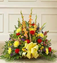 Vibrant Sympathy Basket - A bright and thoughtful sympathy floral basket featuring a cheerful mix of yellow spider mums, red carnations, orange snapdragons or gladiolas, yellow button mums, and purple asters, beautifully accented with fresh greenery.  Finished with a yellow ribbon bow, this arrangement offers a warm, uplifting, and respectful expression of sympathy, combining vibrant colors with elegance to honor and remember a cherished life.