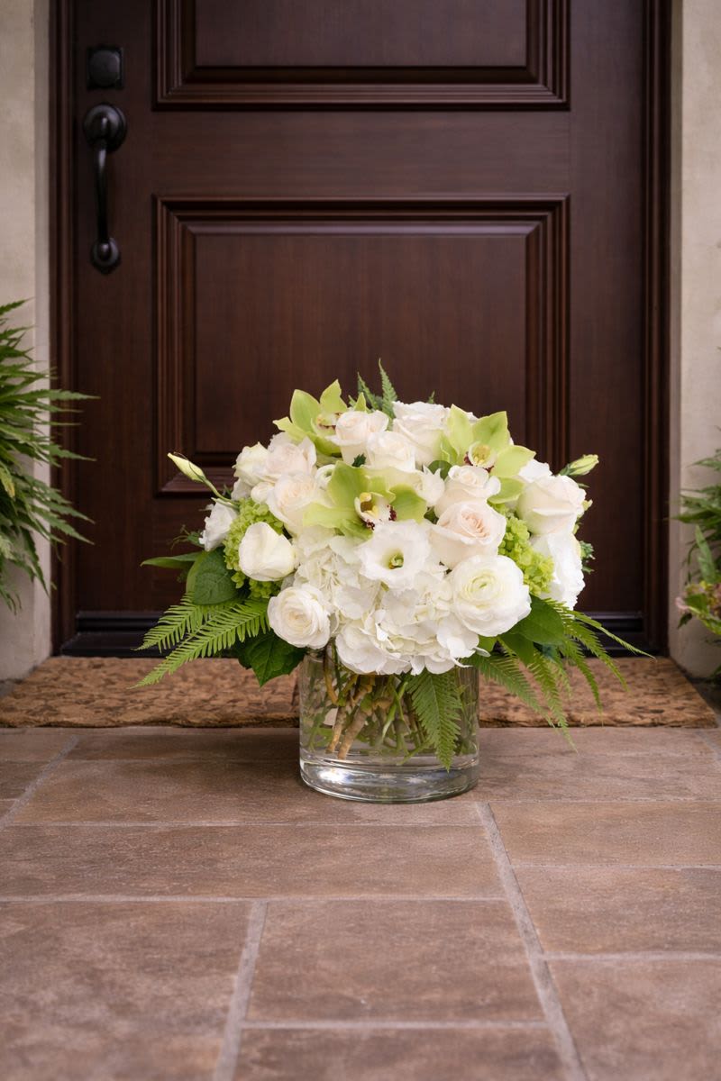 Calming Fern - This elegant and sophicated floral display includes Umbrella fern, White hydrangea, White Roses, Mini green hrangea, Green Cymbidiums, and white Lisianthius