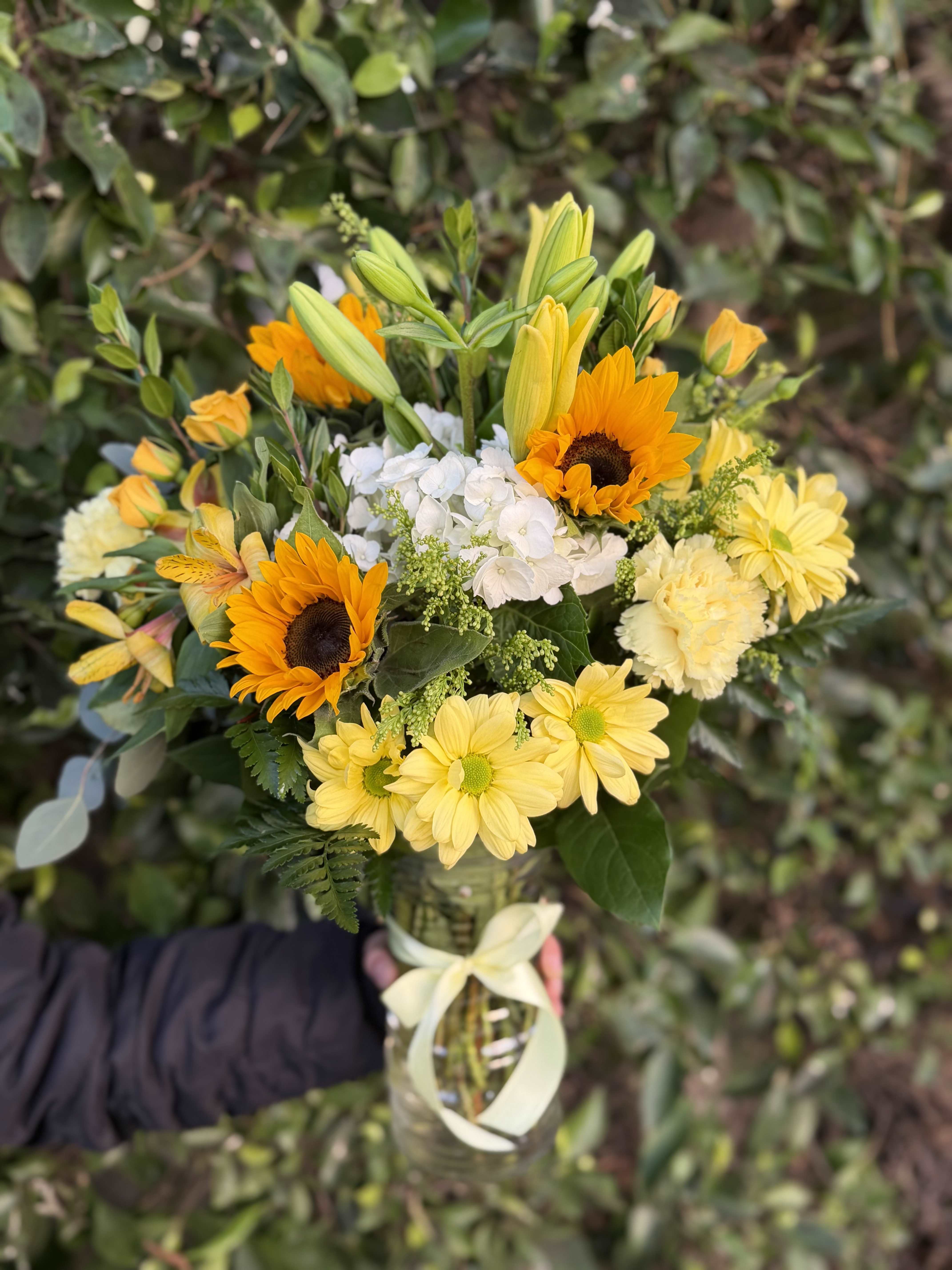 Sol Bloom Vase - A sun-inspired arrangement featuring bold sunflowers paired with soft yellow accents and airy textures. Radiant, modern, and full of warmth.