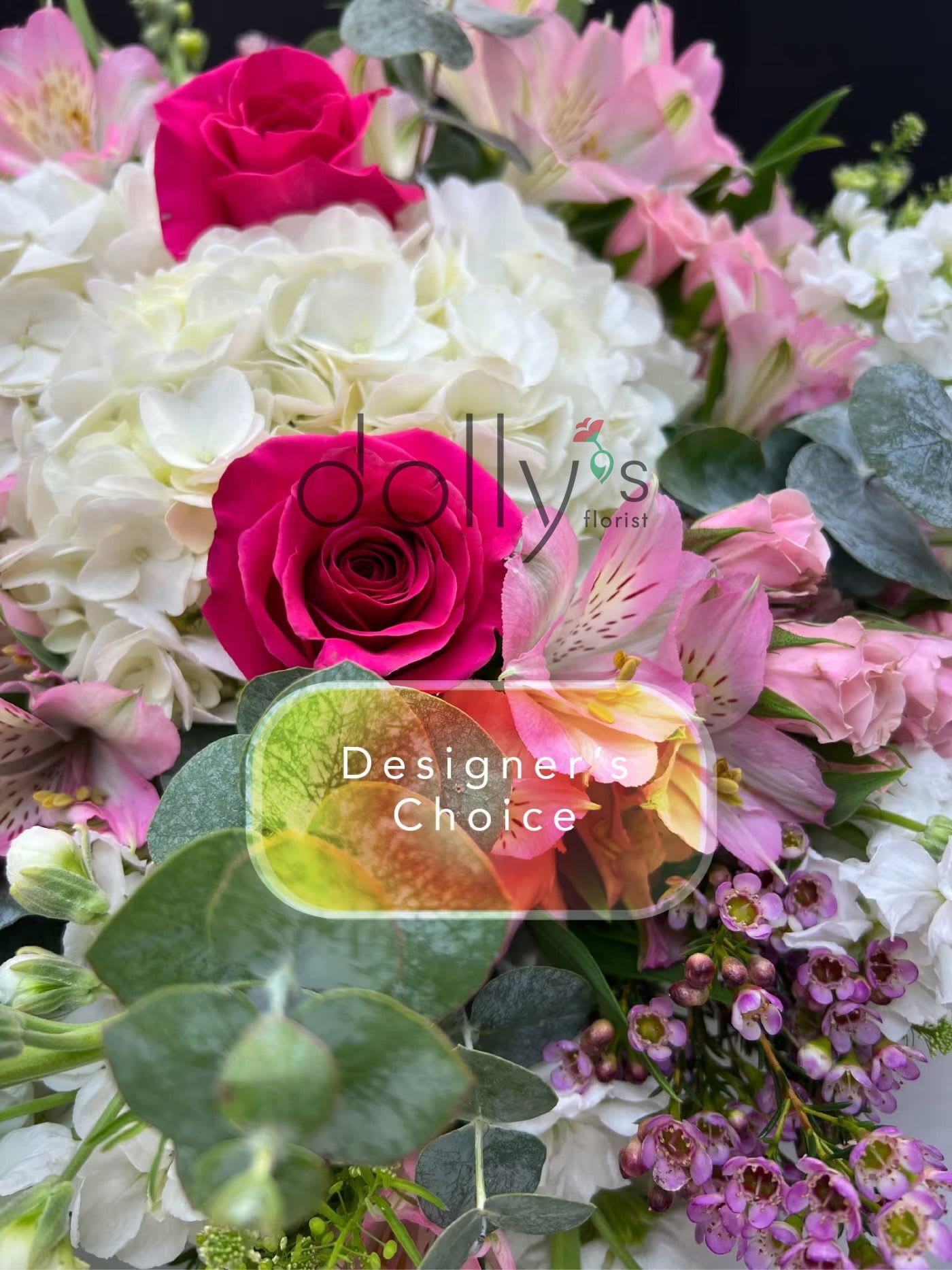 Bright arrangement with hot pink roses, white hydrangeas, and assorted pink flowers.