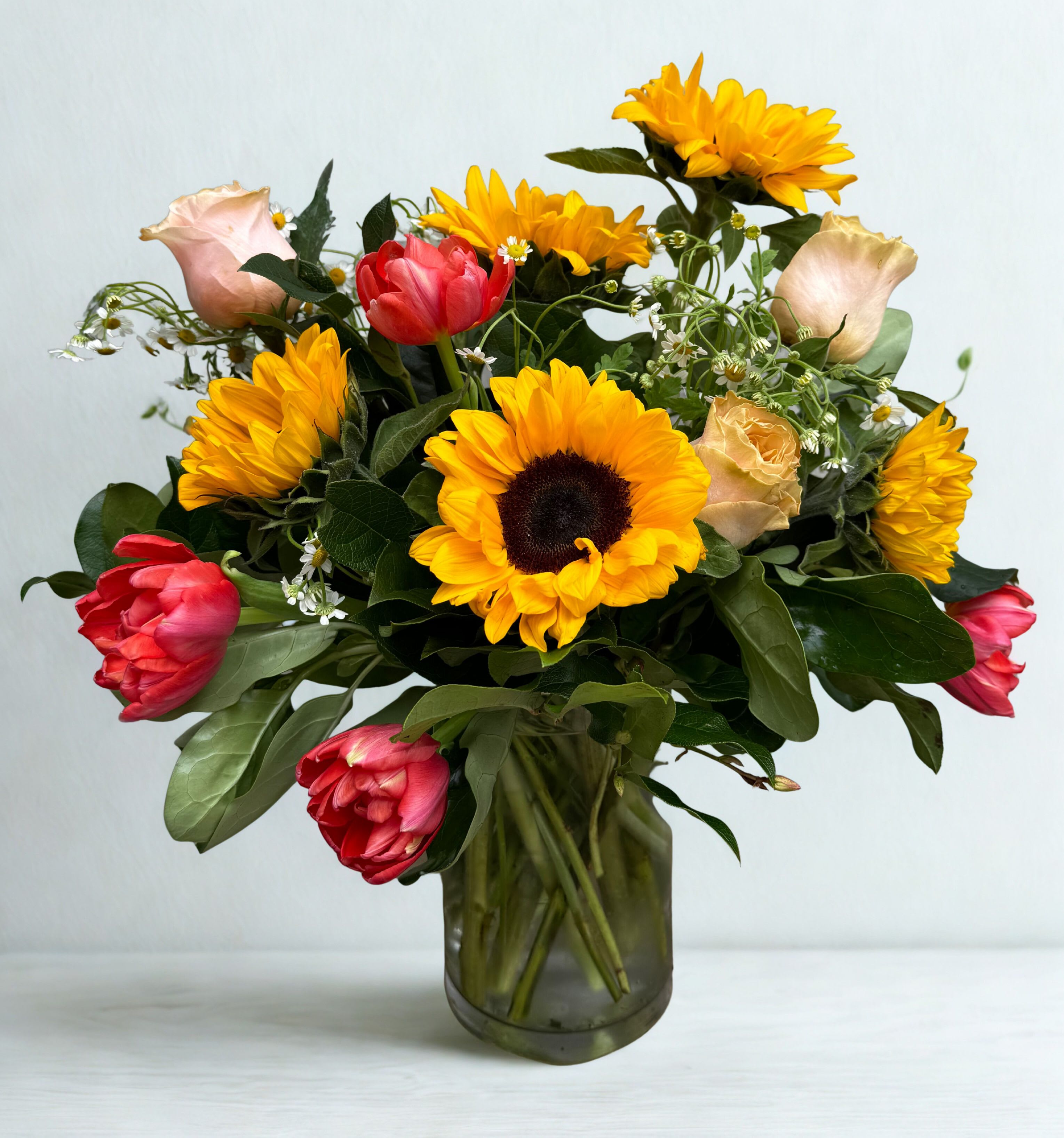 Sunny Spring - Sunny sunflowers, roses and Tulips fill this arrangement full and beautiful! Color of tulips &amp; Roses may vary