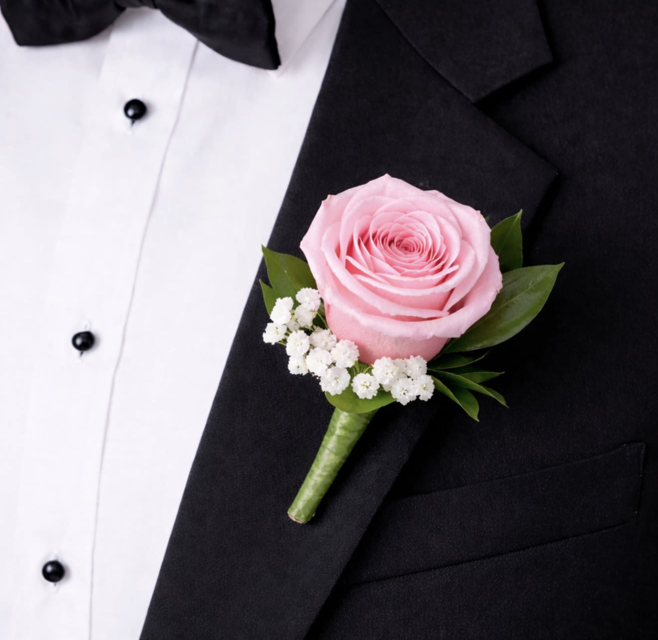 Boutonniere with Light Pink Rose - This light pink rose boutonniere is a timeless lapel accessory featuring a single, elegant light pink rose accented with delicate greenery. 