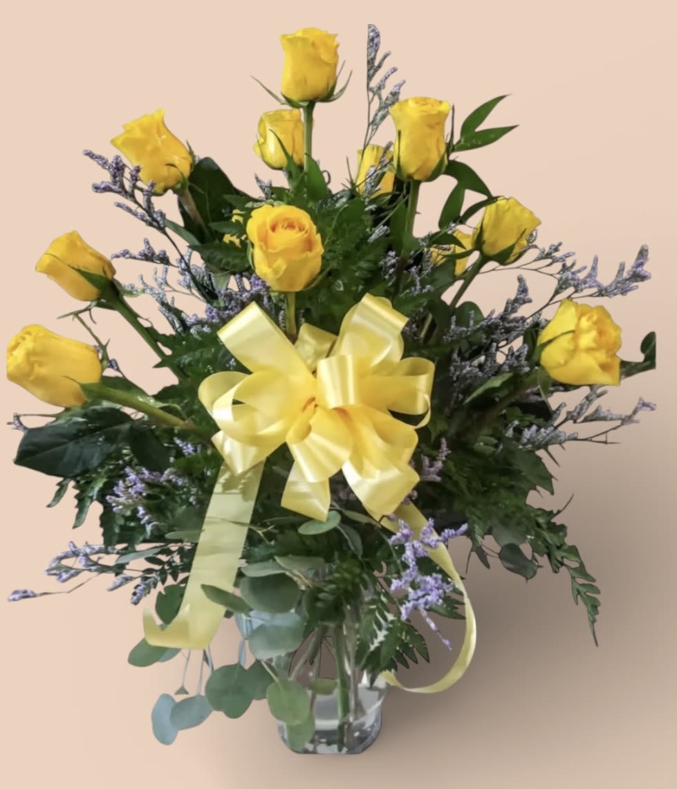 A Dozen of Yellow nothing says friendship like yellow roses - Nothing says friendship like yellow roses. These roses are designed in a clear glass vase with three types of greeneries and Filler. 
