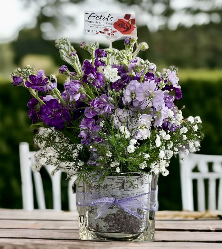Cottage Garden Cube by Petals - Stock is a popular cottage garden flower that has been cherished for centuries in England and was very popular during the Victorian Era. This cube is full of delicately sweet-scented stems of Stock in lovely shades of lavender, purple, and white with a touch of baby’s breath and tree fern. This design will surely delight your recipient. Perfect for any occasion. Thanks, Cheryl. *On occasion, colors may vary due to daily availability.