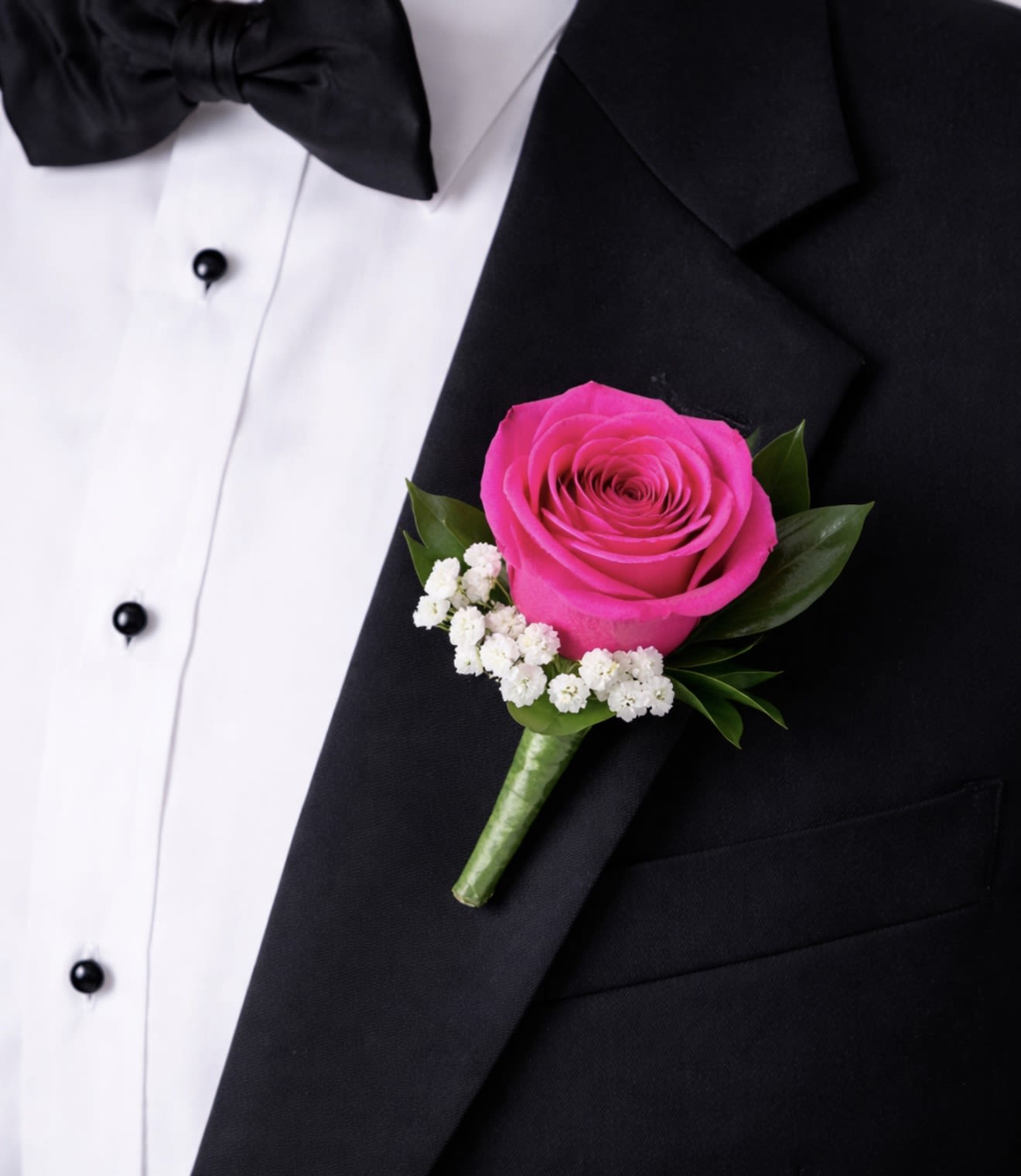 Boutonniere with Hot Pink Rose - This hot pink rose boutonniere is a timeless lapel accessory featuring a single, elegant hot pink rose accented with delicate greenery. 