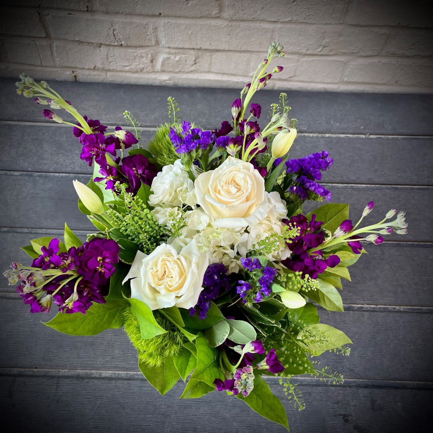 Garden Symphony - The "Garden Symphony" is a sweet and stylish arrangement is in harmony with colors of purple, white and green. This beautiful design is the perfect gift of spring garden flowers such as tulips, roses, and hydrangea 