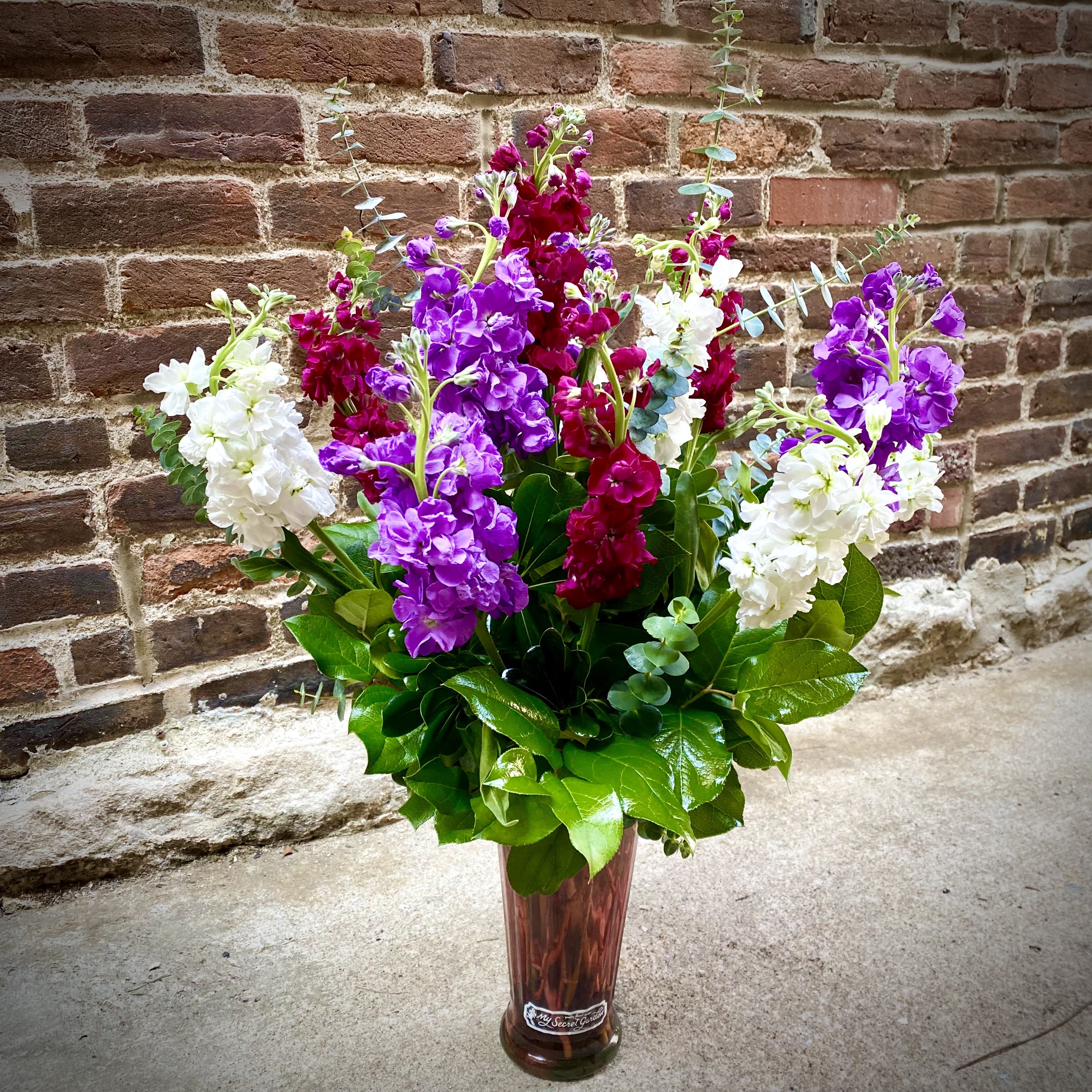 Fragrant and Soft Stock  - Stunning Stock features the soft fragrance and blooms of 13 Stock stems (Matthiola Incana) which is so unique and special. Will be presented in a tall colored glass vase, and feature a variety of beautiful colors. Gift this amazing bouquet of Stock blooms for any special occasion. 