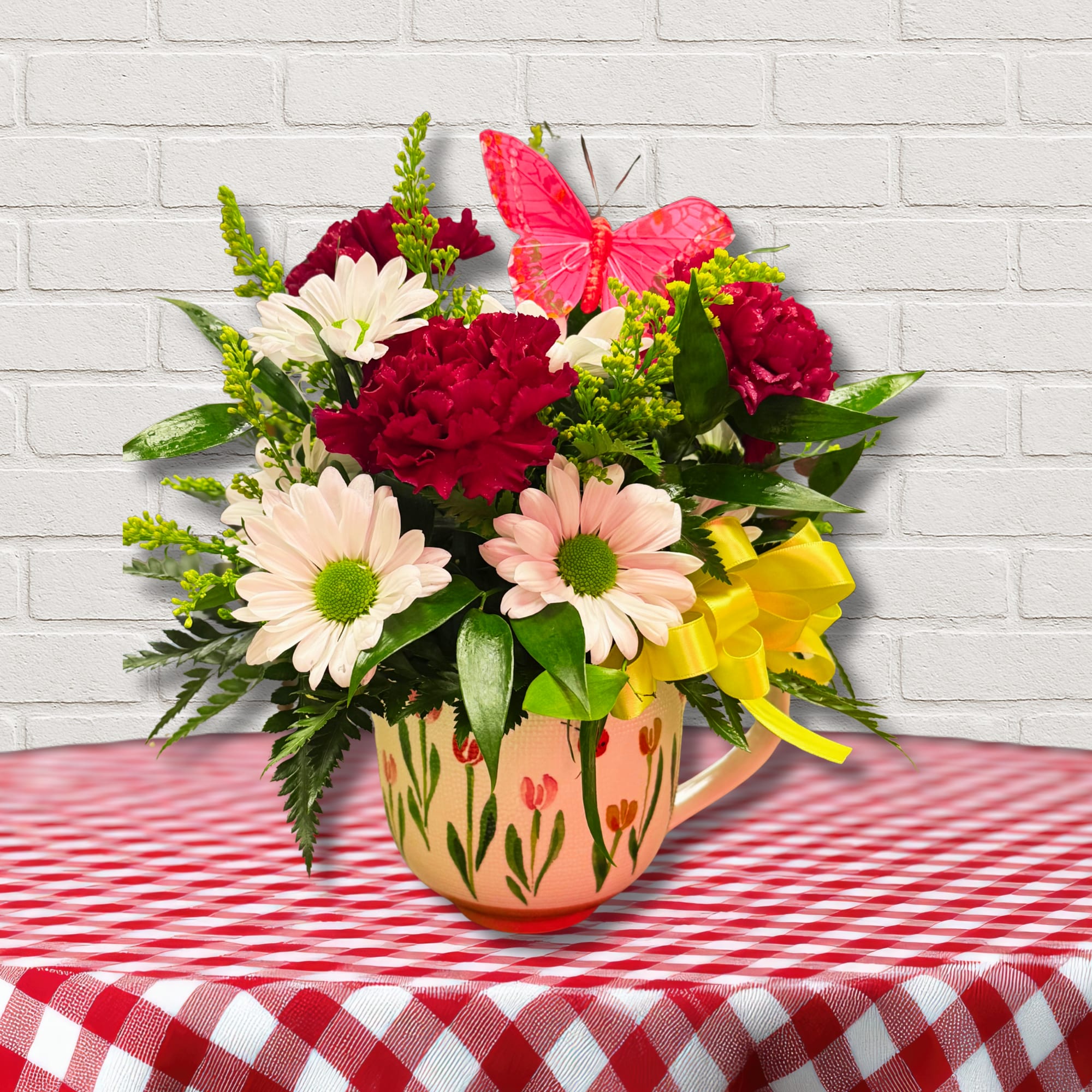 Spring Hug in a Mug - Send a sweet little arrangement in an adorable spring mug!  (*specific mug will vary based on availability).  Flowers with a keepsake! 