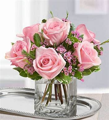 Simply Sweet - Beautiful pink roses with arranged with waxflower and Pittosporum in a clear cube