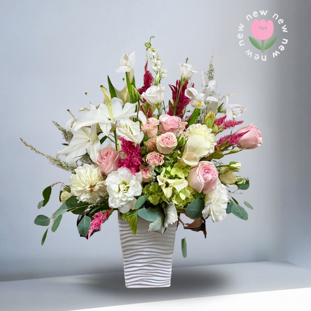 Show me Love - This sweet and elegant SHOWS the love with premium flowers. Recipe: Seasonal Dahlias, Calla Lily, Casablanca Lilies, Spray Roses, Larkspur, Lisianthus, Iris, Amaranthus, and Hydrangaes. Season: Seasonal Dahlias Orientation: Front Facing View Picture shown: Standard