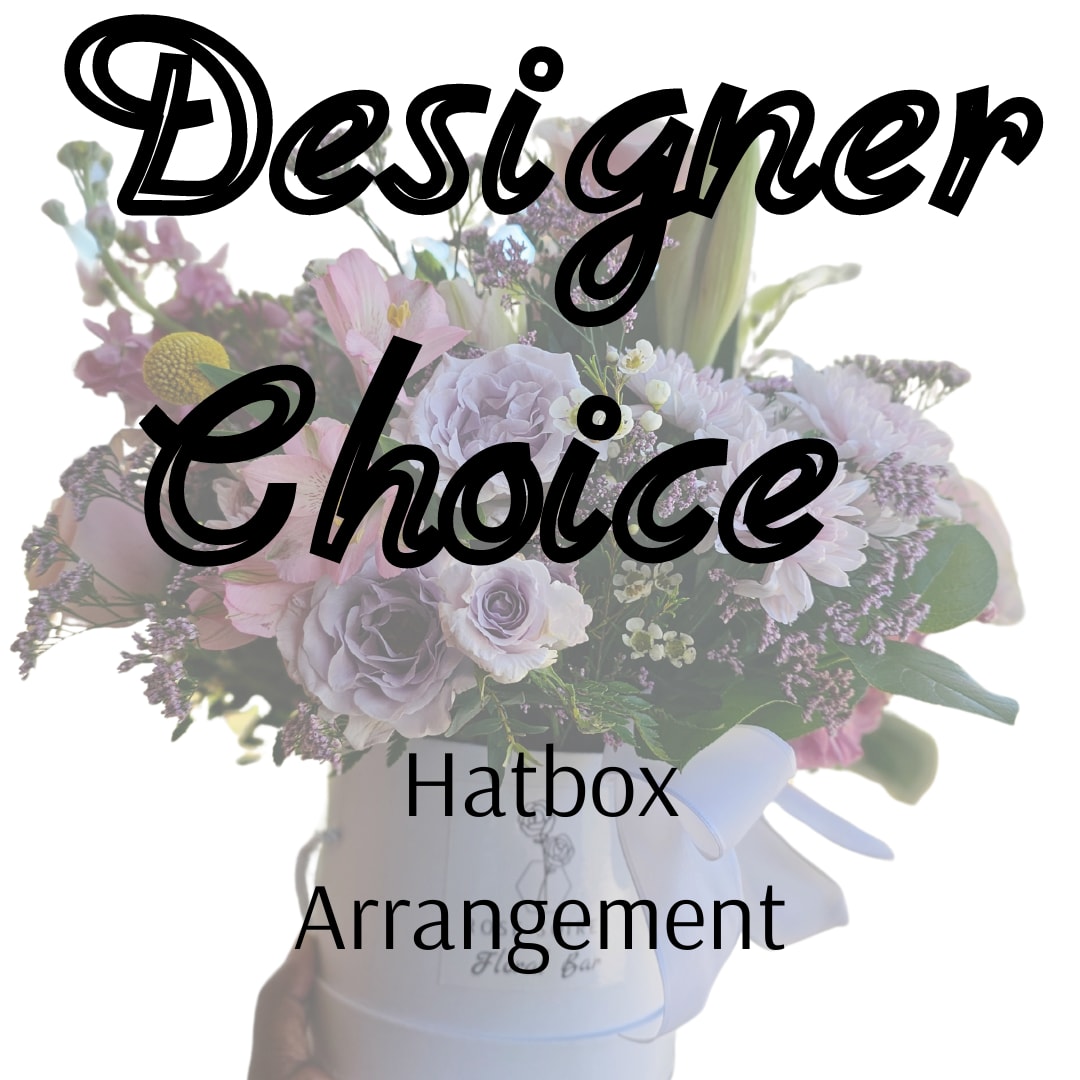 Designers Choice Hatbox Arrangment - The Designer’s Choice Hatbox Arrangement allows our team to create a one-of-a-kind floral design using the freshest blooms available that day. Styled in our signature hatbox, each piece is thoughtfully composed with balance, texture, and color in mind.  Perfect for those who trust the creative process, this option ensures you receive the best florals of the moment in a design that feels fresh, elevated, and unique.  Each arrangement is created using a curated selection of seasonal florals. Specific varieties and color palettes will vary based on availability while maintaining a cohesive and intentional design.  Standard Box is approximately 5" x 5.5" Deluxe Box is approximately 6.5" x 6.5" Premium Box is approximately 7.25" x 7.25" 