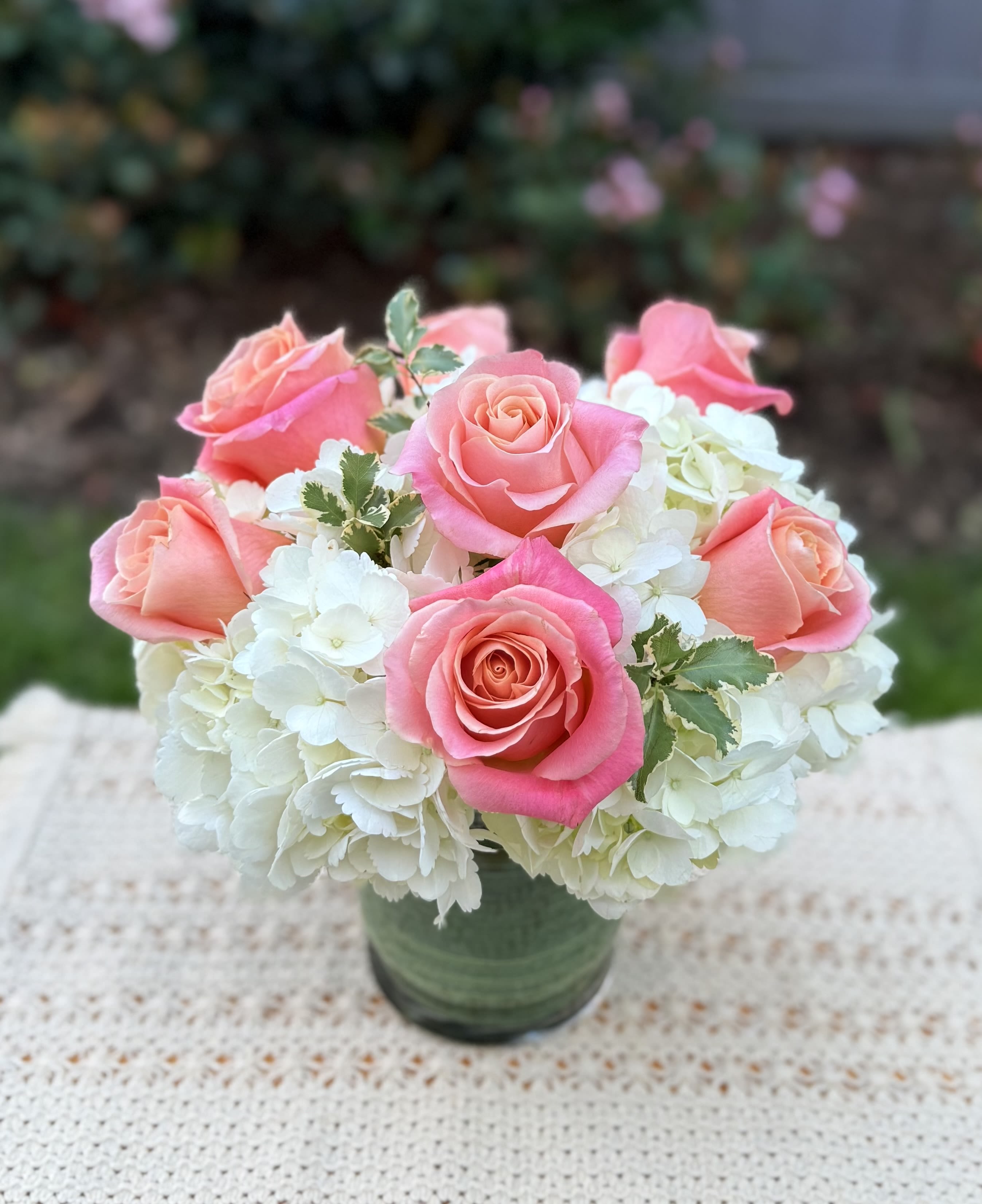 “ Beverly “ Classic Hydrangea Arrangement  - Beautiful Classic arrangenment crafted with beautiful hydrangeas and Ecuadorian roses, accented with green foliage. It includes a clear glass vase. Medium size Classic style. Pink peach and white tones. 