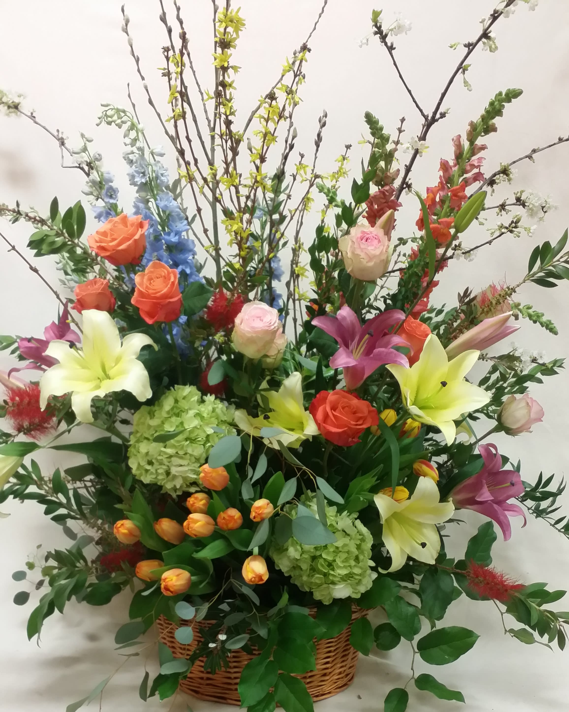 "Spice of Life" Spray - A striking display of beautiful flowers! Bright and colorful, this sympathy spray is sure to convey all the joys life has to offer. Varieties of flowers will vary by season, but rest assured the design is consistently beautiful.