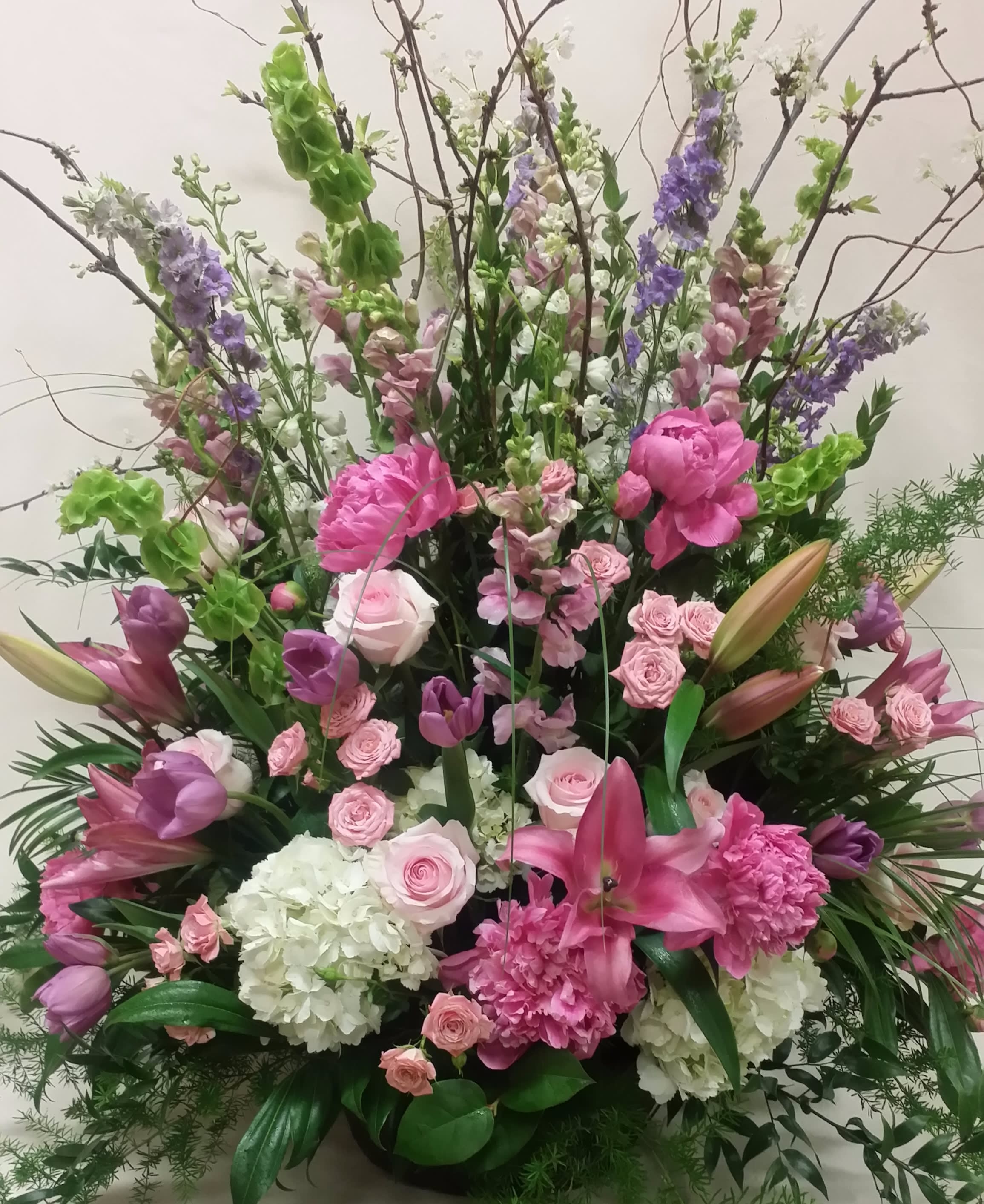 "Reminiscence" Spray - A beautiful variety of pink flowers, accented with lavender and white. Lilies, peonys, roses, hydrangeas, and more. Timeless.