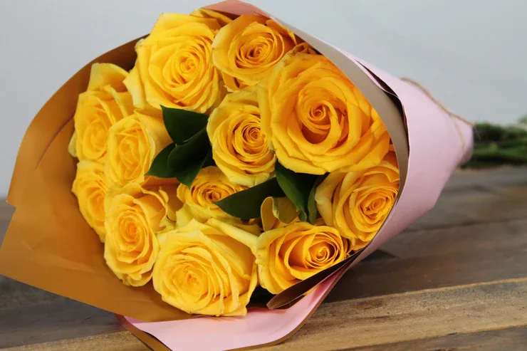 Tender Affection - Elegant arrangement of a dozen exquisite yellow roses, beautifully presented in waterproof floral wrap to ensure lasting freshness.