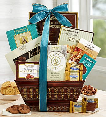 Gourmet gift basket filled with assorted cookies, caramels, nuts, and snacks with a teal bow