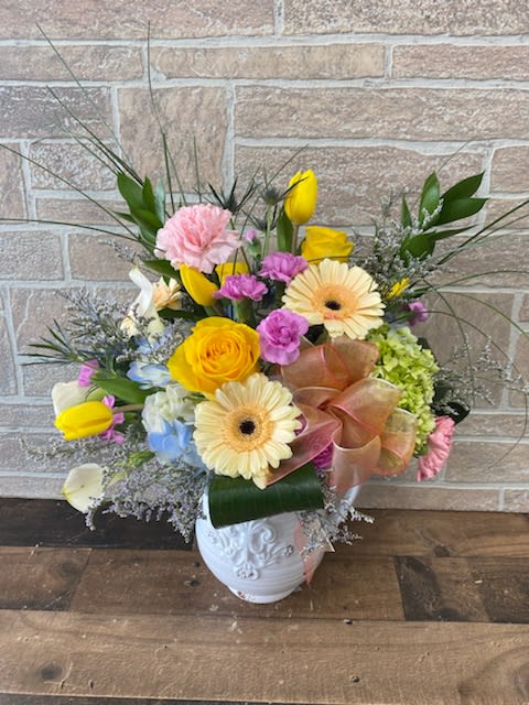 Susan's Splendor - I am lucky enough to have two Sisters-in-Law named Susan. One is more wonderful than the next. These soft blooms inside a decorative distressed white vase will be a nice keepsake for your loved one.