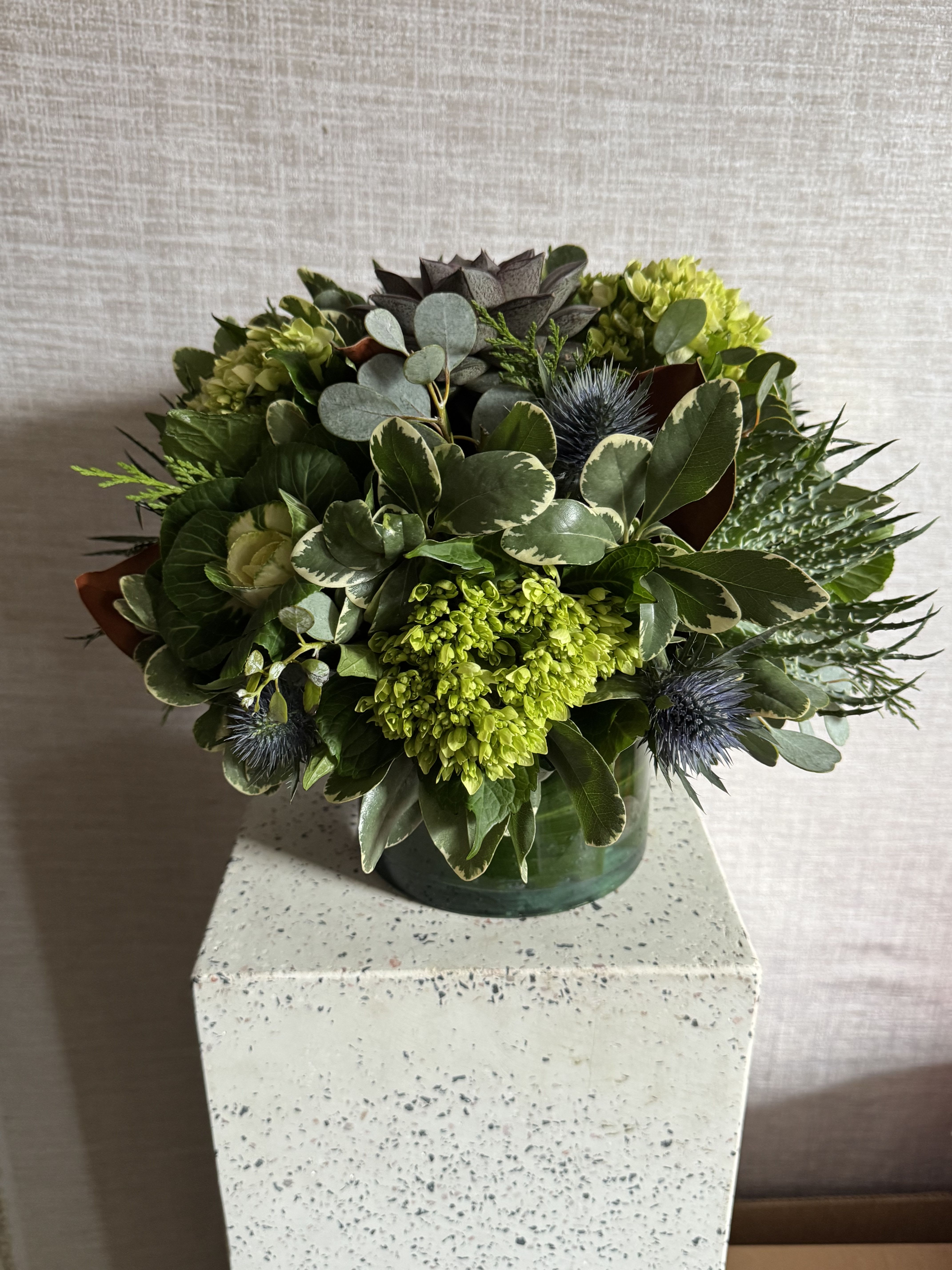 Pure Verde - A lush mix of vibrant greens, rich foliage, and textural succulents featuring bright green Hydrangea and mossy Dianthus accented with bold and structural leaves.  