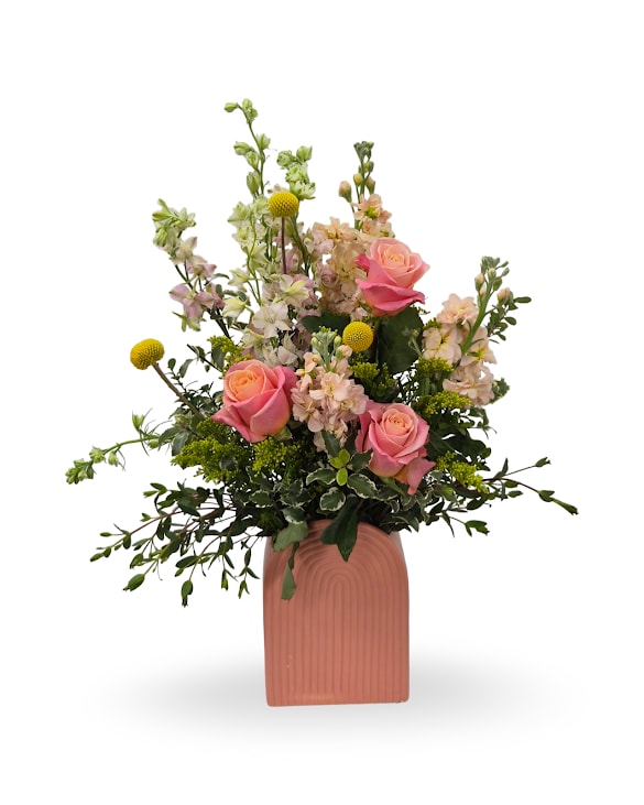 Sunrise Bliss - Select this vibrant and eye-catching " Sunrise Bliss arrangement featuring warm peach roses, peach stock, pops of crespedia and more.   Approx. 23" x 13" x 8.5"