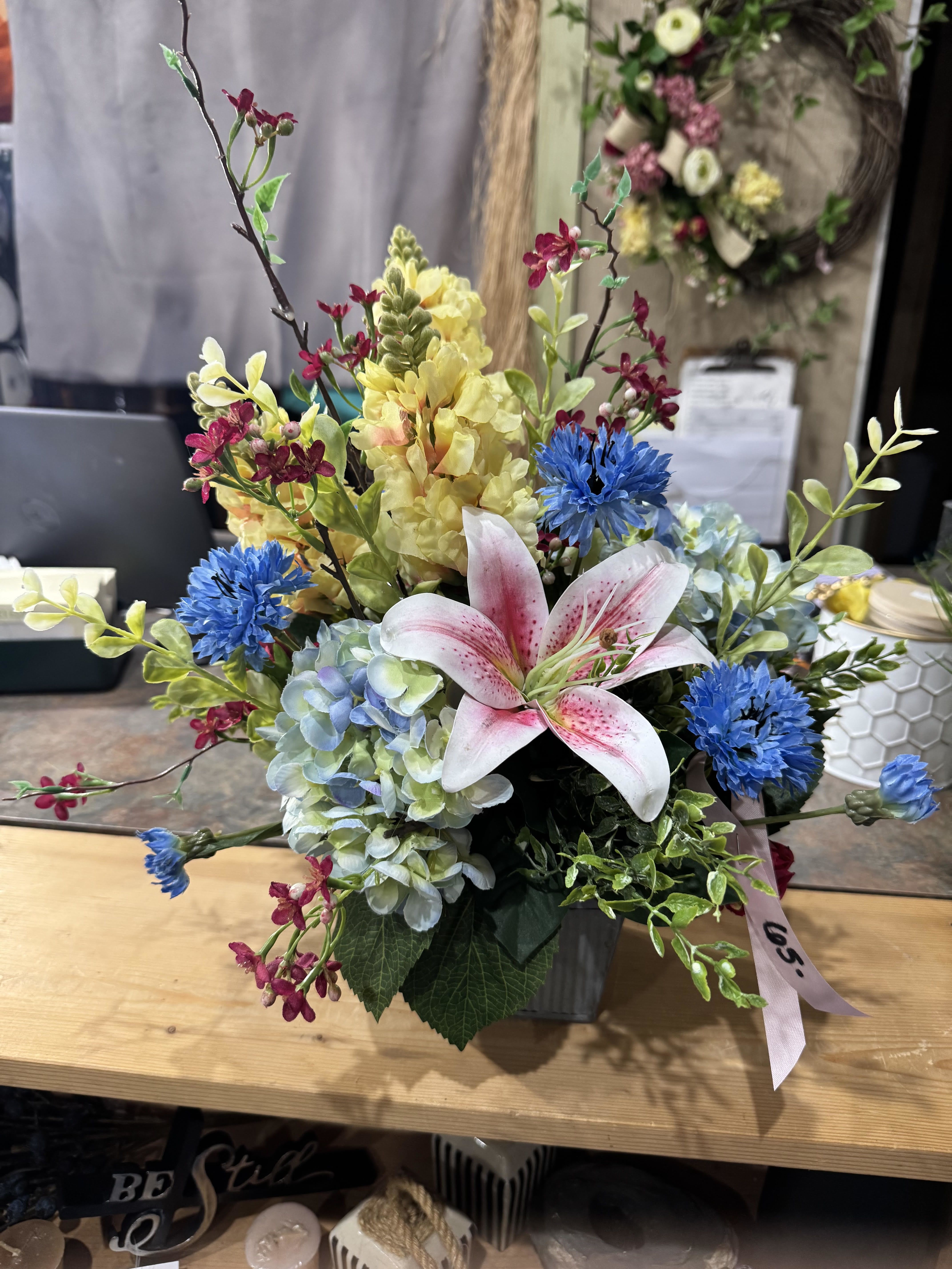 SPRING LILY (PERMANENT ARRANGEMENT) - A silk (permanent arrangement) with faux blooms in yellows, blues, and pinks