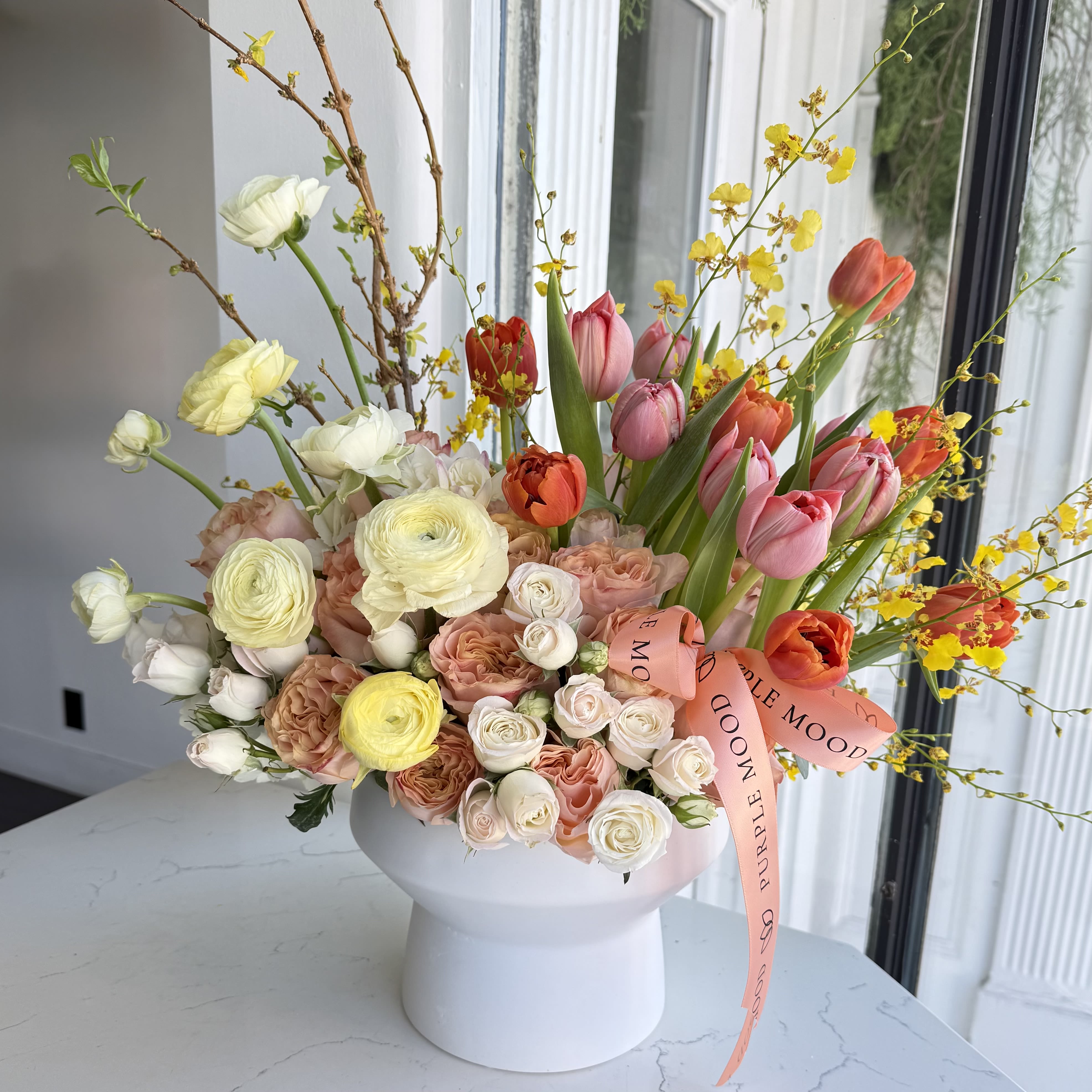 March Vase - Inspired by the arrival of spring, March Vase features a beautiful mix of fresh tulips and seasonal blooms arranged in a soft, natural style. This elegant composition celebrates the freshness, warmth, and renewal that the month of March brings.