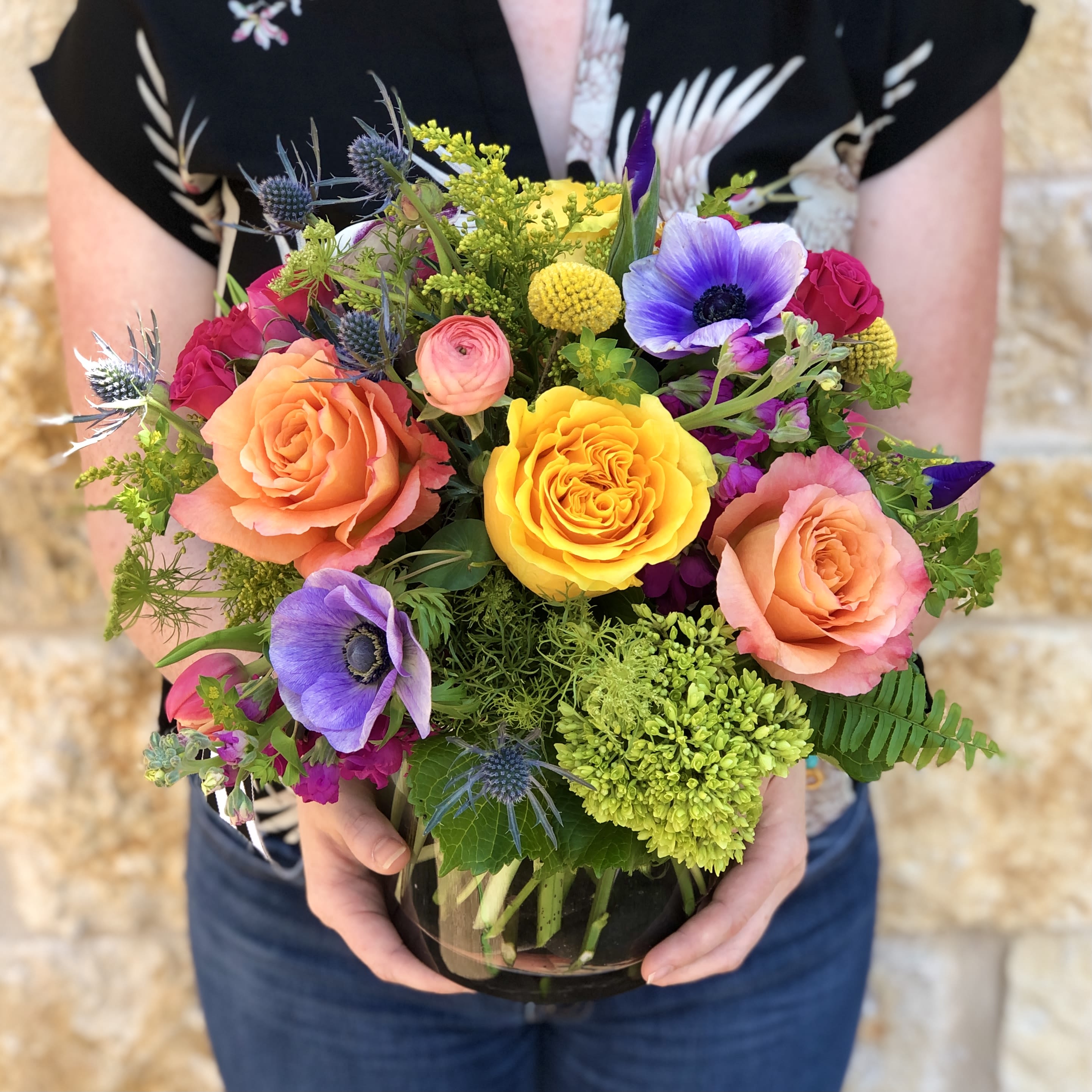 Lush Vibrant Garden  - A bright and colorful seasonal garden mix. Arranged low and dense in our signature English garden style. Delivered in a clear glass vase. Floral varieties may vary but will be of similar quality and style. Overall design is approximately 13" x 13" in the standard size. 