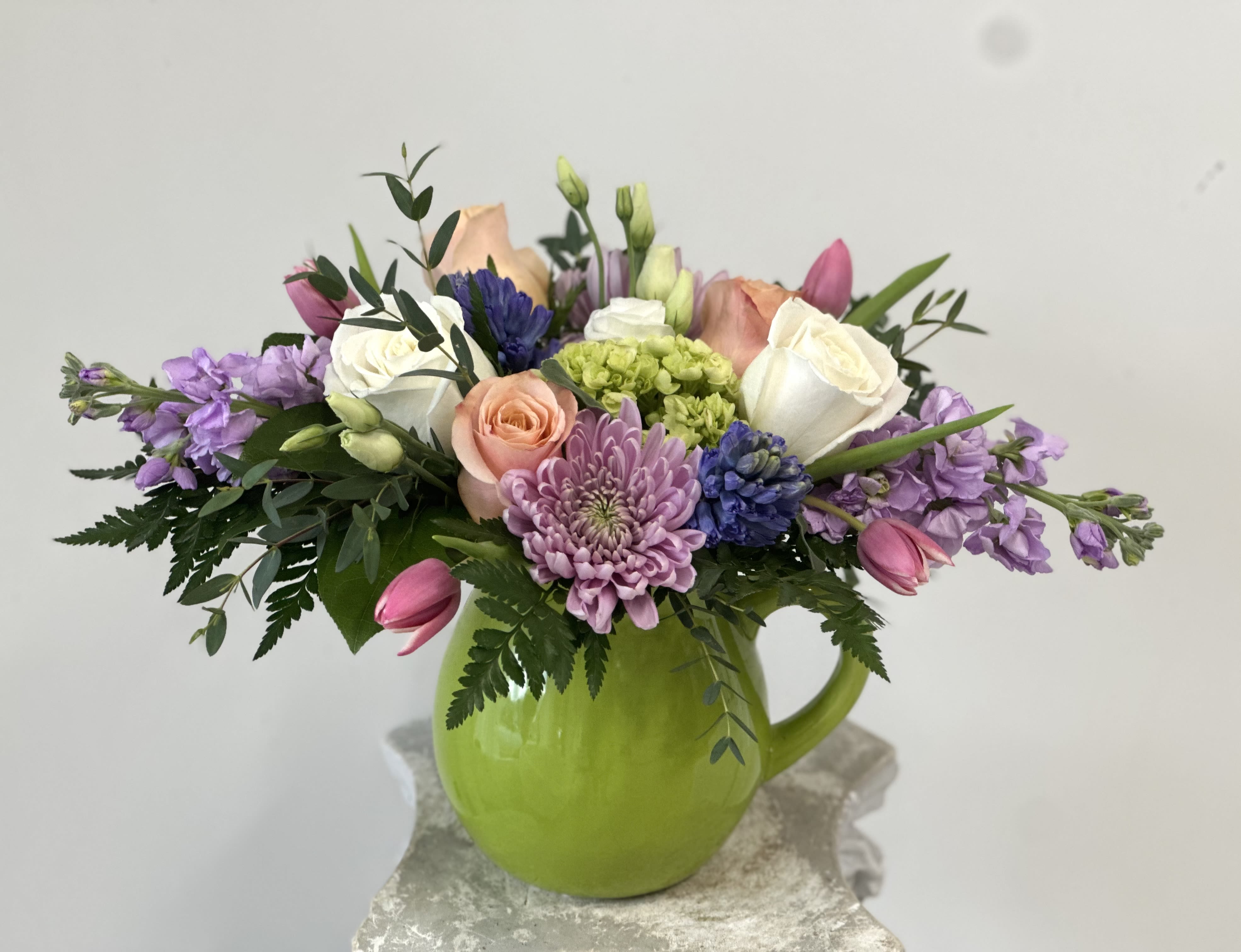 Monet Garden by Westford Florist Art by Veny - Transform your space with the enchanting beauty of Monet Garden, a breathtaking floral creation from Westford Florist Art by Veny. Imagine stepping into a vivid daydream where each petal flutters like a brushstroke in Claude Monet’s iconic palette, capturing nature's elegance and charm. This exquisite arrangement is not merely a collection of flowers; it is an enchanting visual experience that transports you to serene landscapes blooming in soft pastels—delicate pink roses whispering sweet secrets next to playful peach ranunculus and ethereal lavender sprigs. Designed thoughtfully for those who appreciate life's artistry, *Monet Garden* infuses tranquility into any environment, making it the perfect centerpiece for your home or workspace. Its gentle fragrances weave through the air like melodies on the breeze, inspiring creativity while nurturing your spirit—a true testament to the harmony art can bring into our everyday lives! Indulge yourself or gift someone special this stunning arrangement that promises to breathe life and color into their world, inviting all who encounter its splendor to revel in perpetual springtime bliss!  