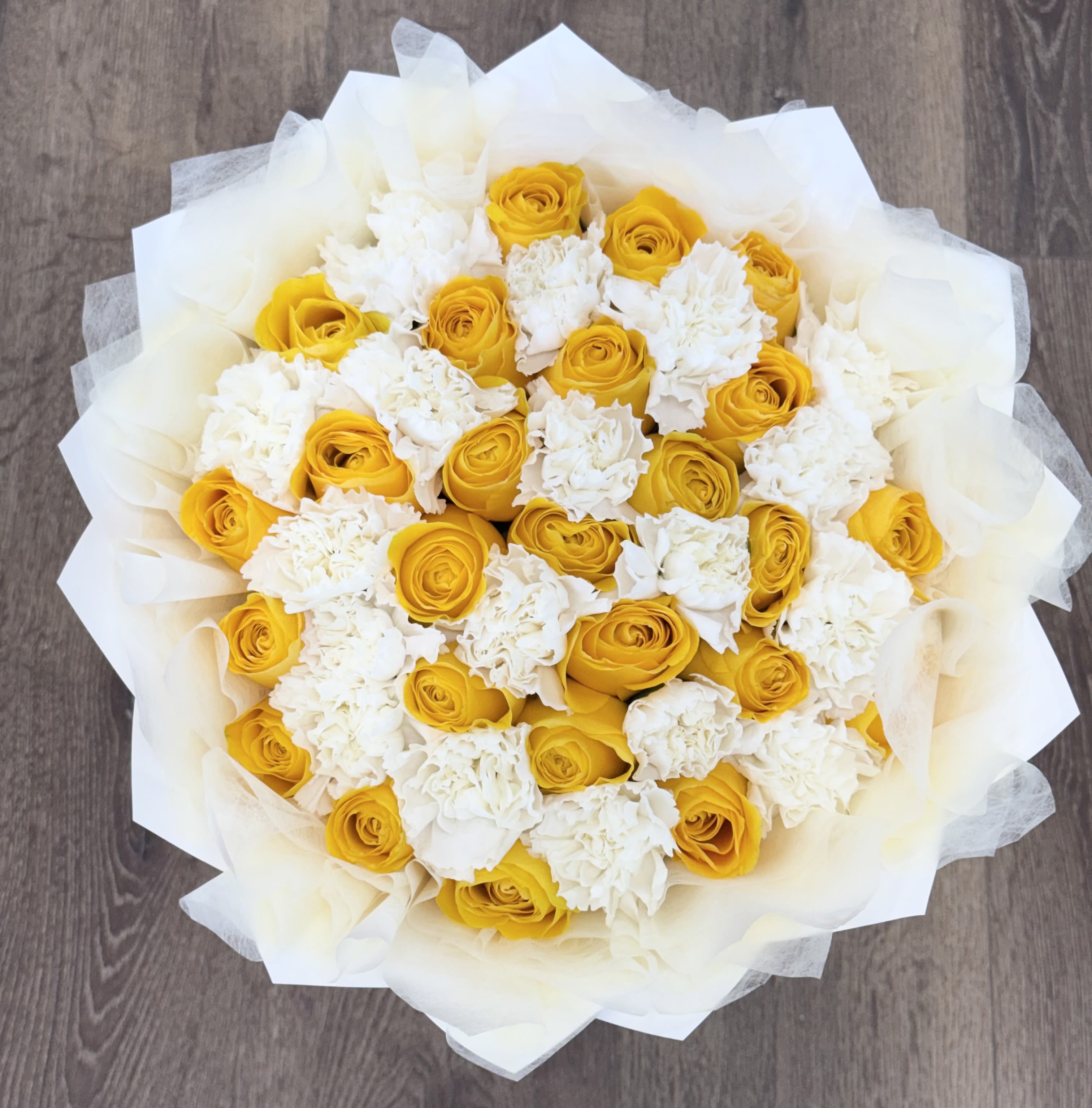 Yellow Rose and White Carnation Bouquet - 25 Yellow roses mixed with carnations wrapped in white paper and tissue. (In-Store Product)