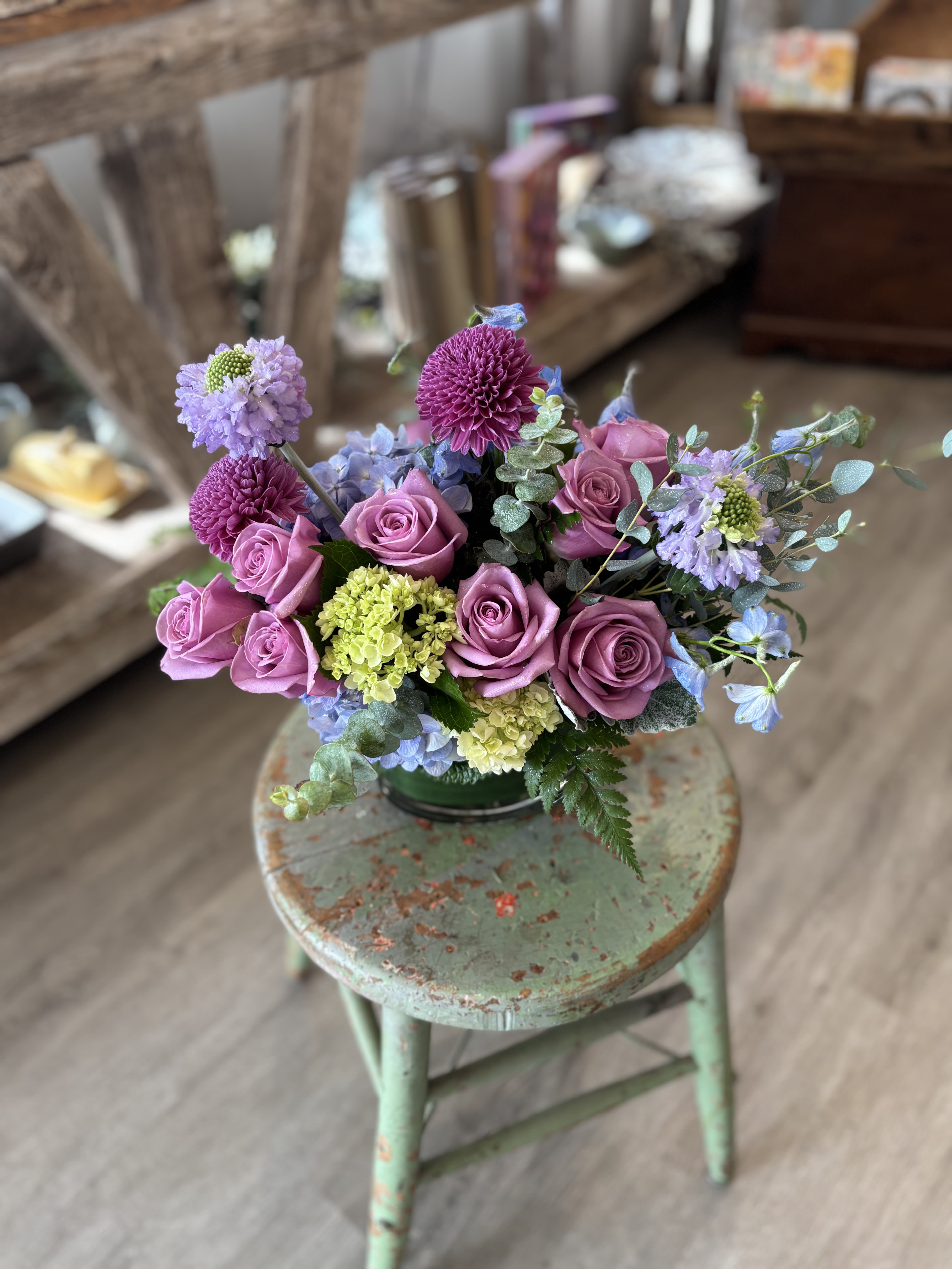 Lavender Fields  - A lush, garden-style arrangement in soft lavender and blue tones featuring roses, hydrangea and delphinium. Romantic and effortlessly elegant - like a little spring garden gathered just for you. 