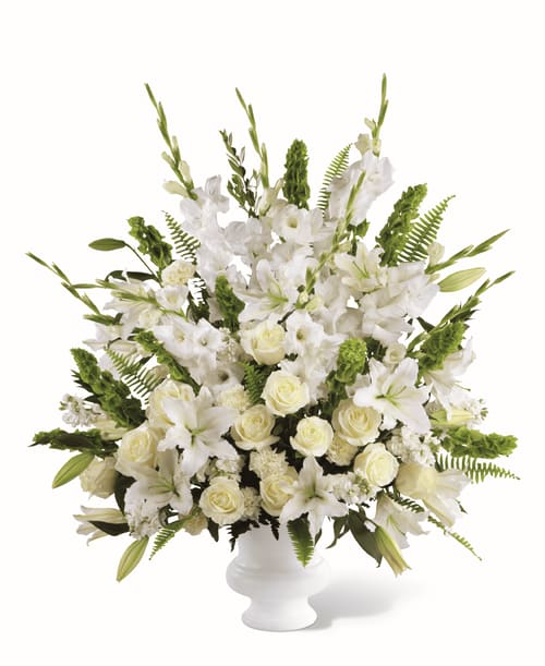 Morning Stars Bouquet - FTDs' Morning Stars Bouquet is a peaceful and calming arrangement of white flowers, including roses, carnations, and lilies. Accented with green Bells of Ireland and lush foliage, this arrangement offers a serene tribute to any loved one. FTD S2-4438p  To allow for the freshest blooms possible, we may substitute for a different variety or color of flower. 