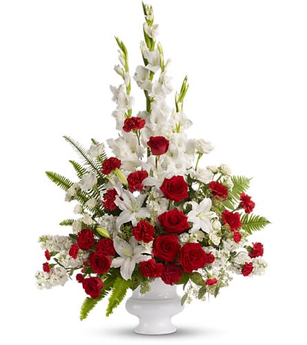 Memories to Treasure - For the sweet spirits who touch our lives a classic pairing of red and white that is both vibrant and respectful. Beautifully contained in a white plastic urn. A mix of fresh flowers such as red and white roses, oriental lilies, graceful gladioli, carnations and fragrant eucalyptus. Approximately 31" W x 43" H Orientation: One-Sided As Shown : T226-2A