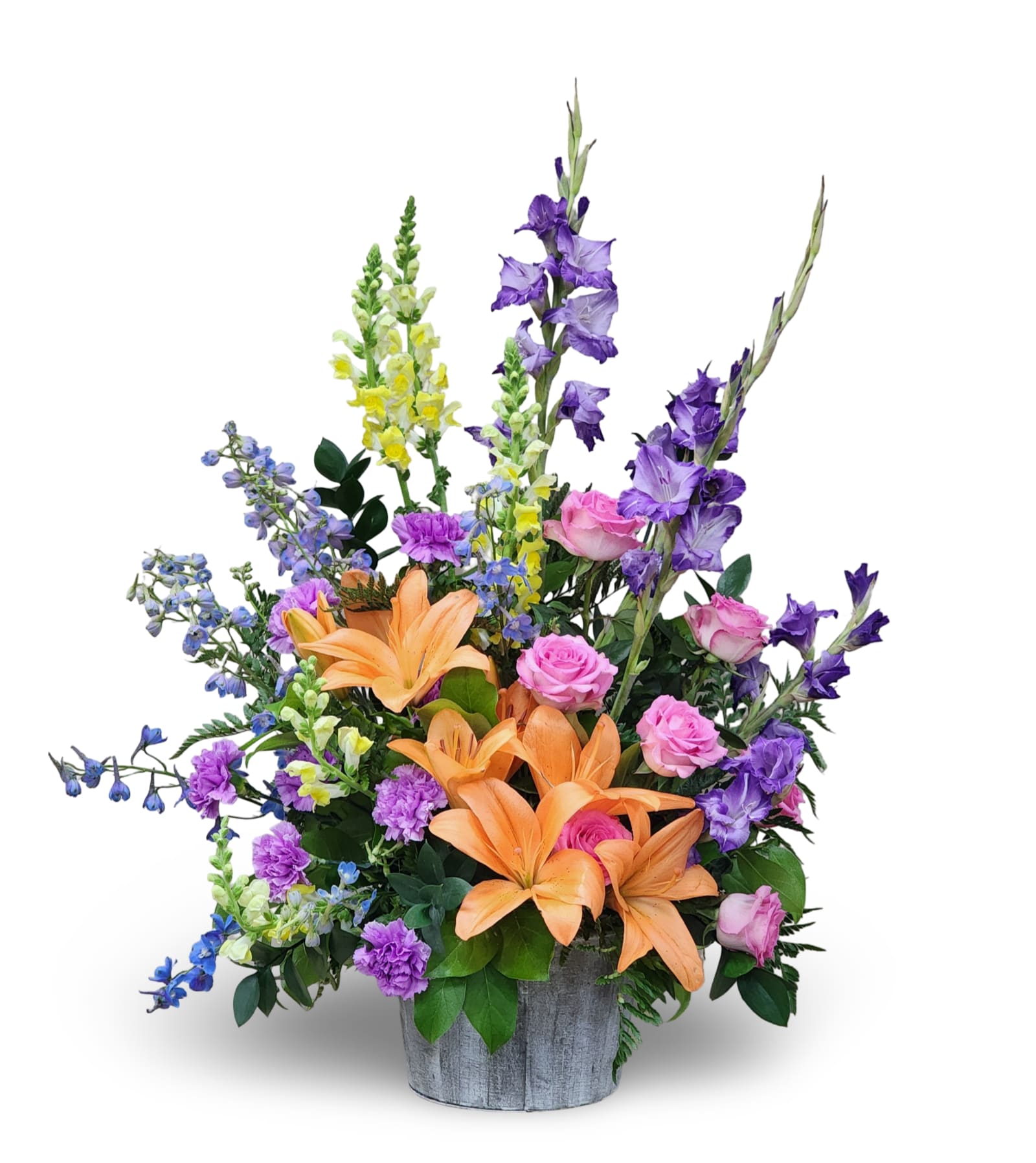 Bright Memories  - Bright Memories is a large, one-sided arrangement standing approximately 37 inches tall by 26 inches wide. Designed in a rustic wooden pot, it bursts with vibrant seasonal blooms in a mix of cheerful colors. Perfect for funerals, celebrations, or special events, this arrangement brings warmth and beauty to any setting.   Exact flower varieties and colors may vary, ensuring each piece is uniquely special. 