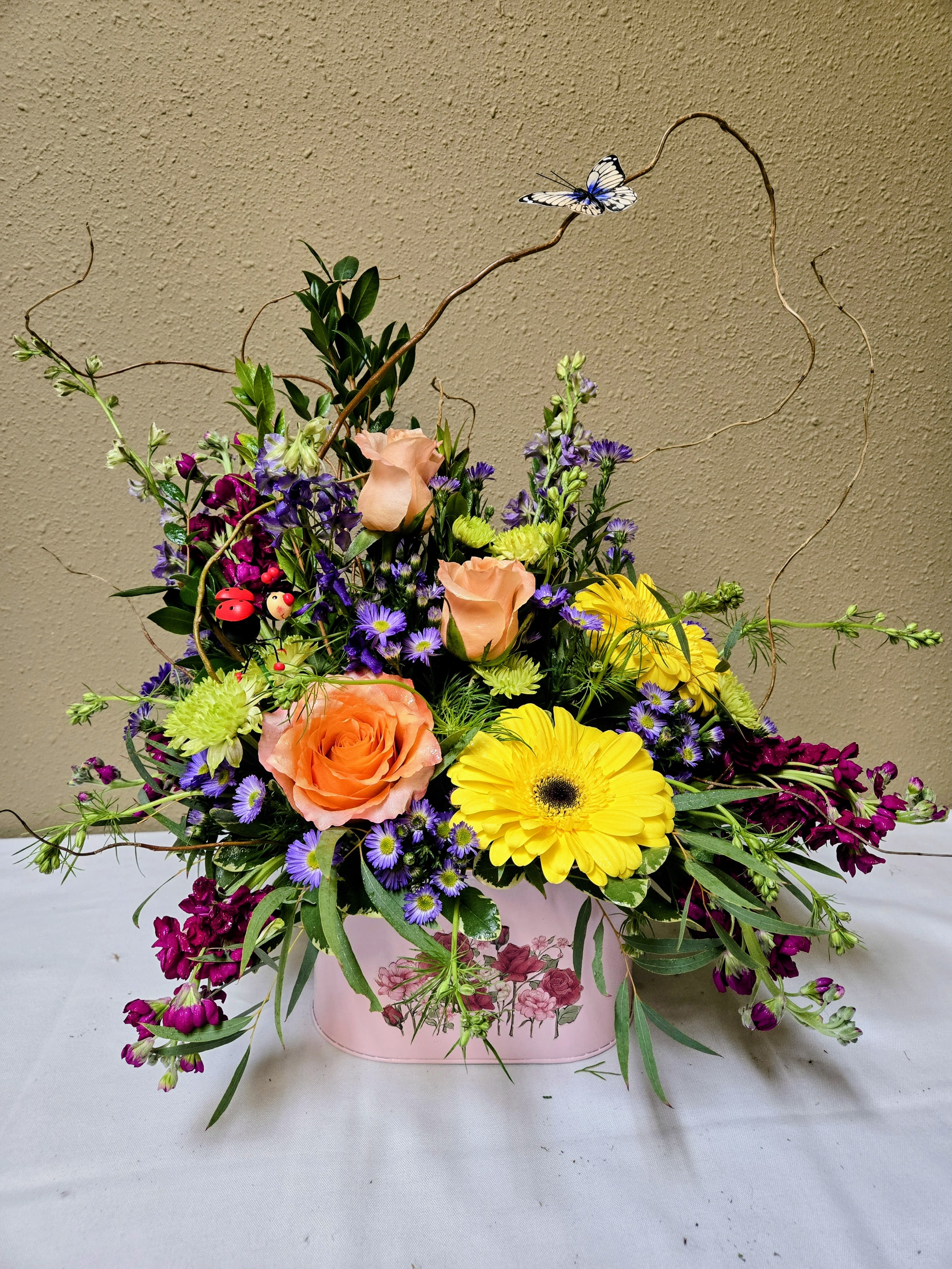 Cora - Colors and flowers may vary based upon availability.