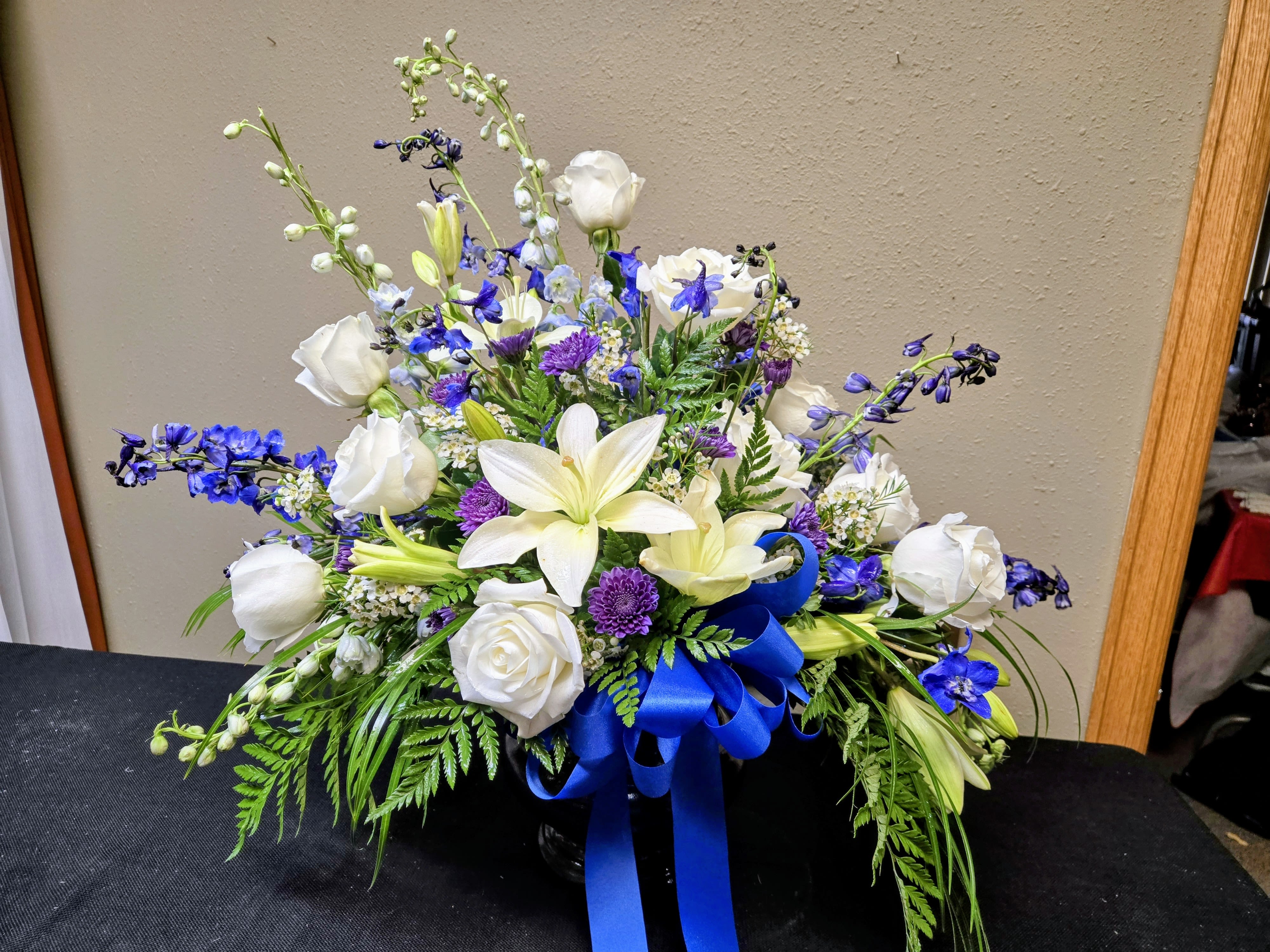White &amp; Blue Sympathy piece - Colors and flowers may vary based upon availability.