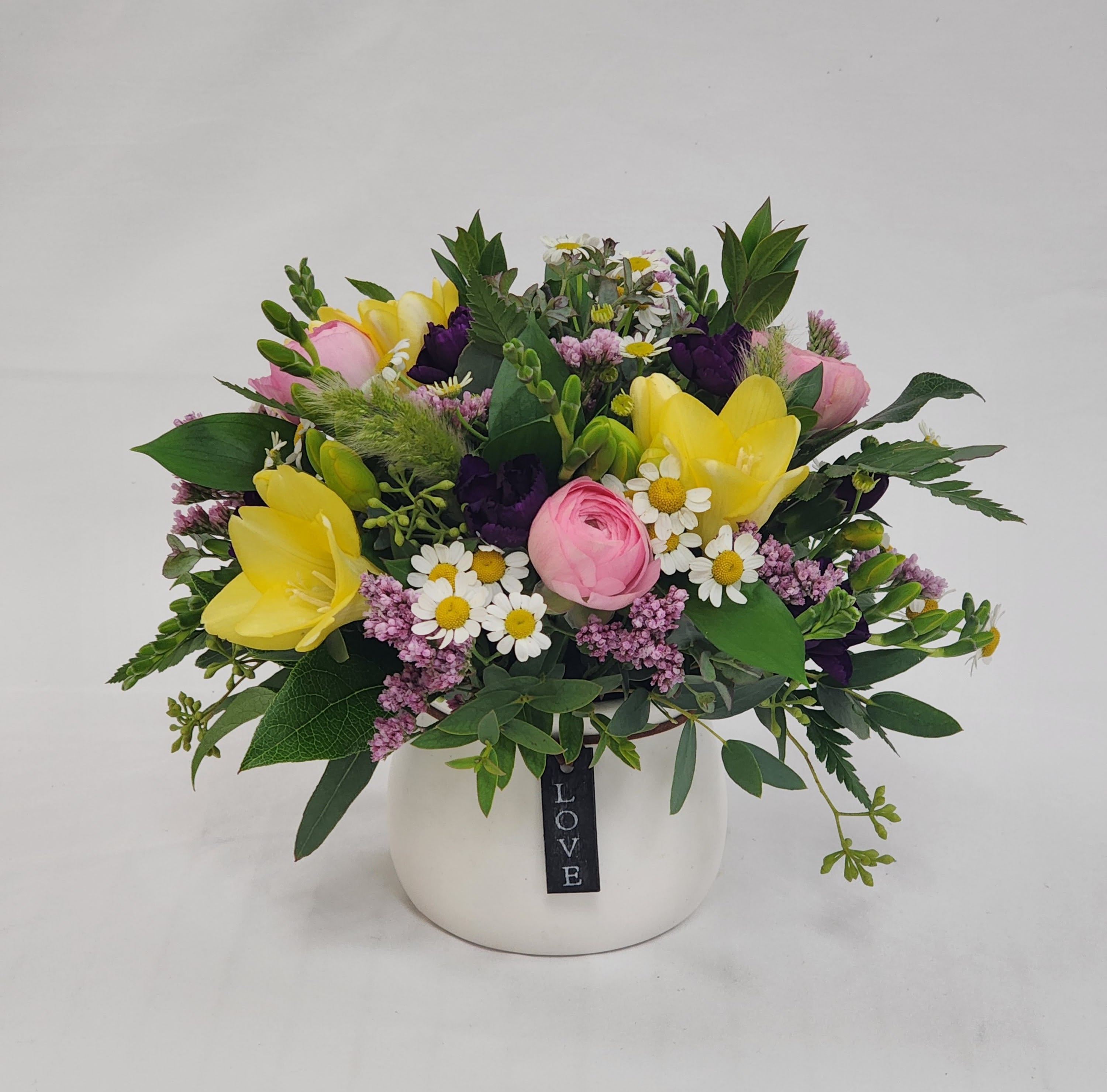 Magic Meadow - Select this mini arrangement to freshen up your Valentine's Day! Featuring an assortment of colors, this little love pot is certain to bring lots of joy.  Roughly 7.5" tall, 9" long, and 7.5" wide.