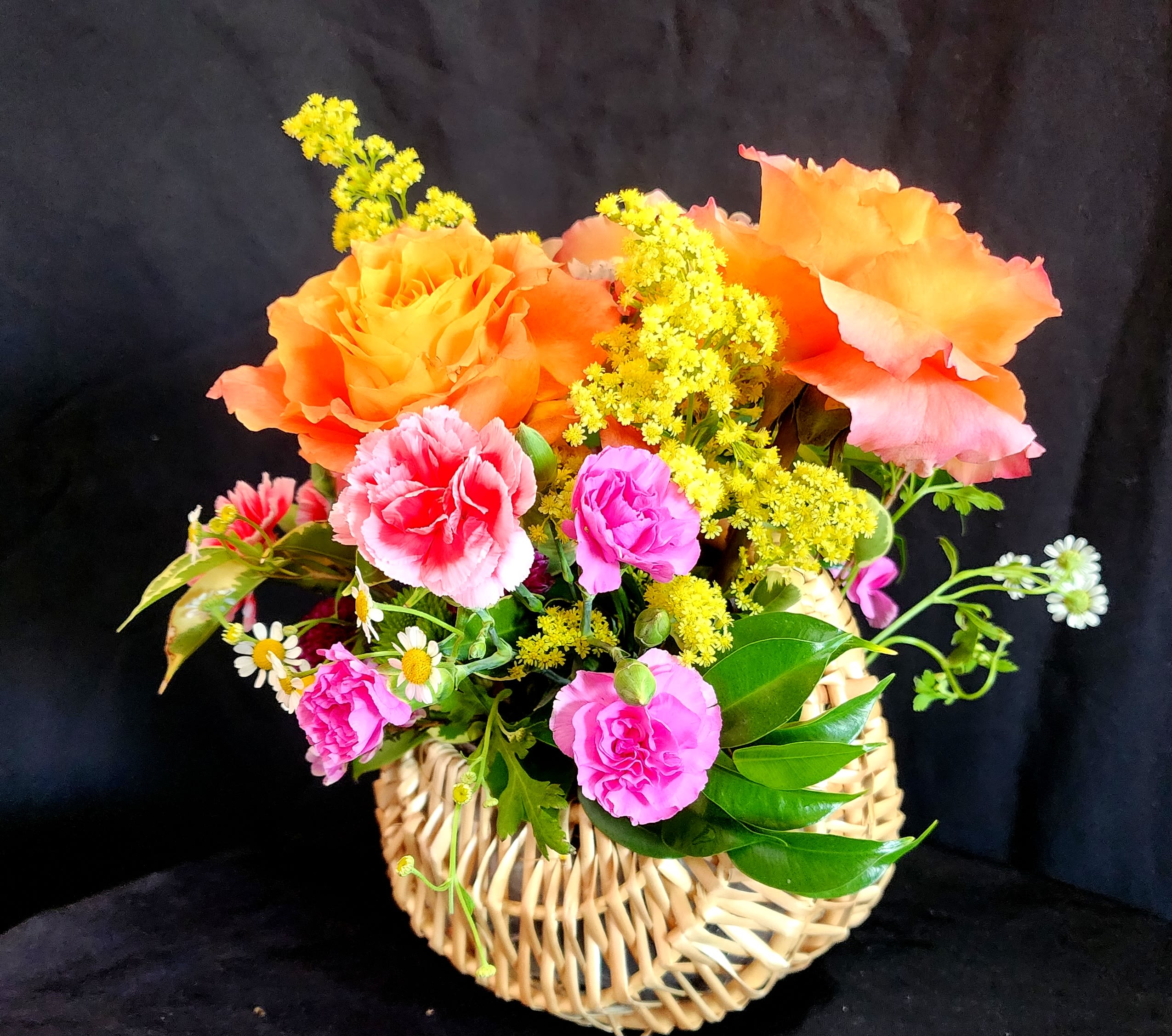 Basketful of Love - Surprise your loved one with a basketful of love for that special occasion or event. This beautiful basket made of straw includes roses, carnations, chamomile, greens and small pom pons.  size is approximately 11x11x10.  You can choose the color of roses (red, white, pink, yellow, free spirit) make sure to include it in the special instructions. 
