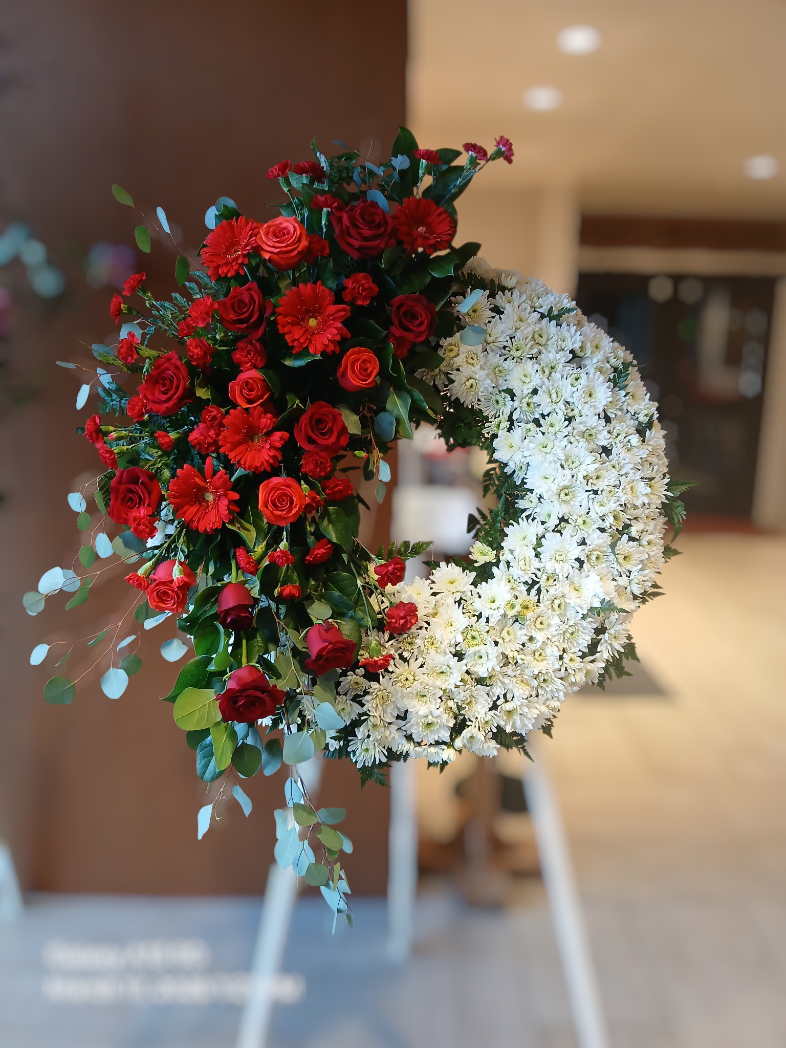 Forever In Our Hearts - Honor a dearly departed with a beautiful and elegant sympathy wreath. Our Red and White Sympathy Wreath is beautifully arranged with assorted fresh flowers to create a lovely presentation and will display your most heartfelt condolences.