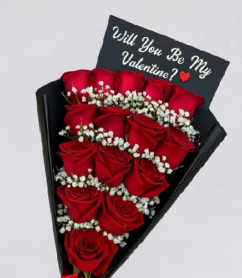Elegance Bouquet  - Deep, velvety red roses set in neat rows create a bold, passionate statement-this hand-tied flower arrangement is a romantic bouquet perfect for Valentine's Day, anniversary roses, or a proposal. The dramatic black paper wrap and a tucked greeting card that reads "Will You Be My Valentine?" make the intention unmistakable: this is the kind of gift that makes the person you're thinking of feel desired and celebrated.  Clusters of tiny white filler flowers add luminous contrast against the red petals, while the sleek black cone gives the bouquet a modern, couture edge. Arranged for strong visual impact and easy holding, the combination of roses and delicate white accents draws the eye and highlights the richness of the blooms. A coordinating black greeting card is included so your message arrives with the flowers-ideal for asking the big question or marking a romantic milestone.