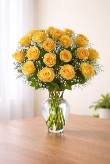 Sunlit Grace Arrangement - A generous cluster of bright yellow roses creates an instant smile-perfect as a birthday bouquet, a cheerful anniversary surprise, or a thoughtful way to say thanks. The Sunlit Grace arrangement brings sunny warmth and approachable elegance to everyday gifting occasions, making the person you're thinking of feel genuinely celebrated and seen.  Rounded, full blooms of yellow roses are softened with small white filler flowers and touches of green, arranged in a classic clear glass vase that showcases the long stems and clean water for a simple, fresh presentation. The compact, open form reads as bright and uplifting on a kitchen table, desk, or mantel. Order with confidence for same-week gifting; refresh with fresh water and a trim to stems every few days to keep the arrangement looking its best.