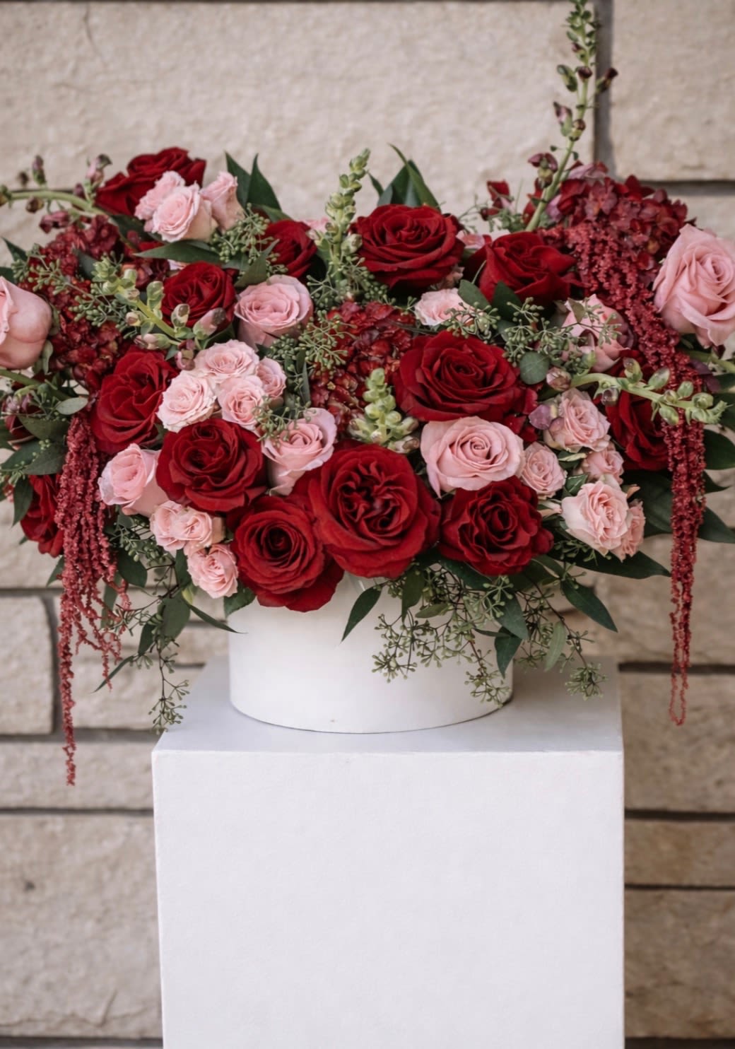 Blushing Romance - A timeless expression of romance and elegance. Blushing Romance is designed to make a statement. This lush arrangement features a stunning blend of rich red and blush roses creating the perfect balance of bold passion and delicate beauty. 