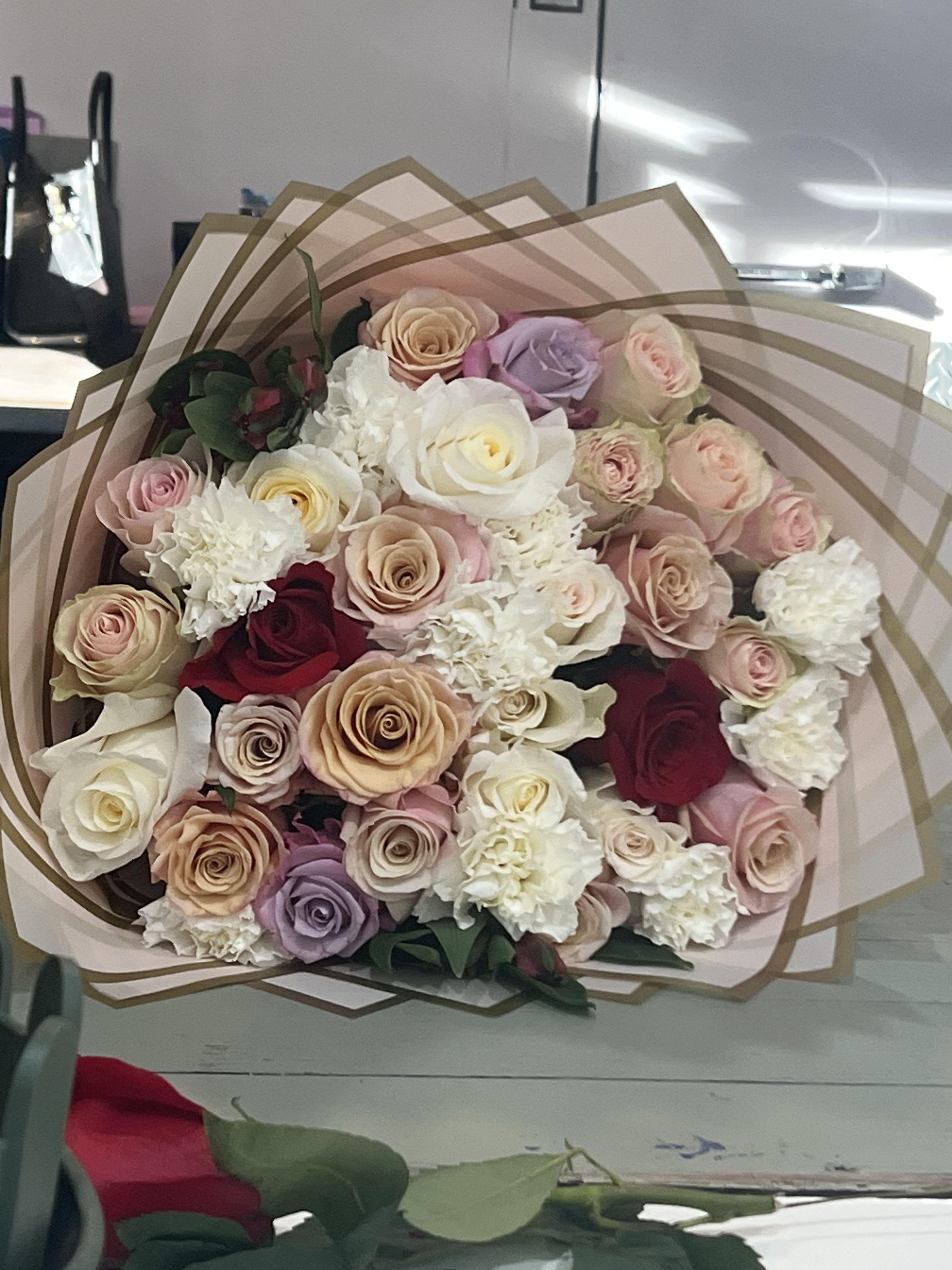 Floral Fantasy by BloomNation™ - A rich riot of colors, this mixed arrangement makes a big impression with all its different textures and premium flowers. Featuring red roses, peach snapdragons, bells of Ireland, purple hydrangea, and stock this arrangement makes a great anniversary or congrats gift.  Approximate Dimensions: 18"D x 25"H