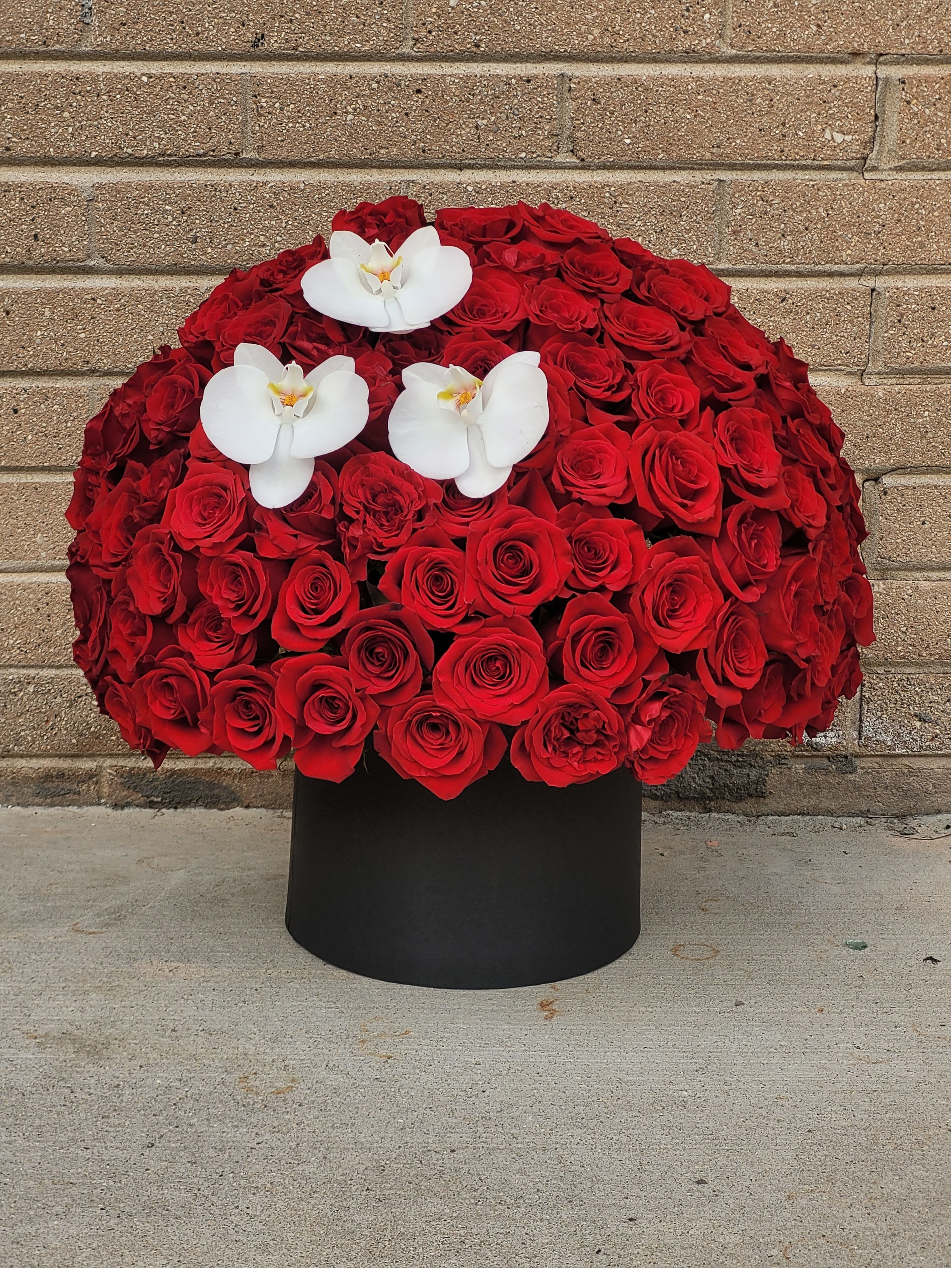 Pretty in Red - Say “I love you” with a luxurious box of velvety red roses paired with elegant orchids—an unforgettable expression of romance, passion, and timeless beauty.