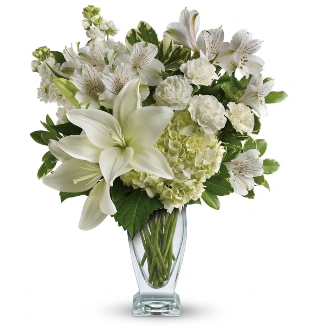 Teleflora's Purest Love Bouquet - Who's the fairest of them all? This snow-white bouquet. A stunning statement of your purest love, this mix of hydrangea, roses and lilies in a Couture vase will take their heart away.  