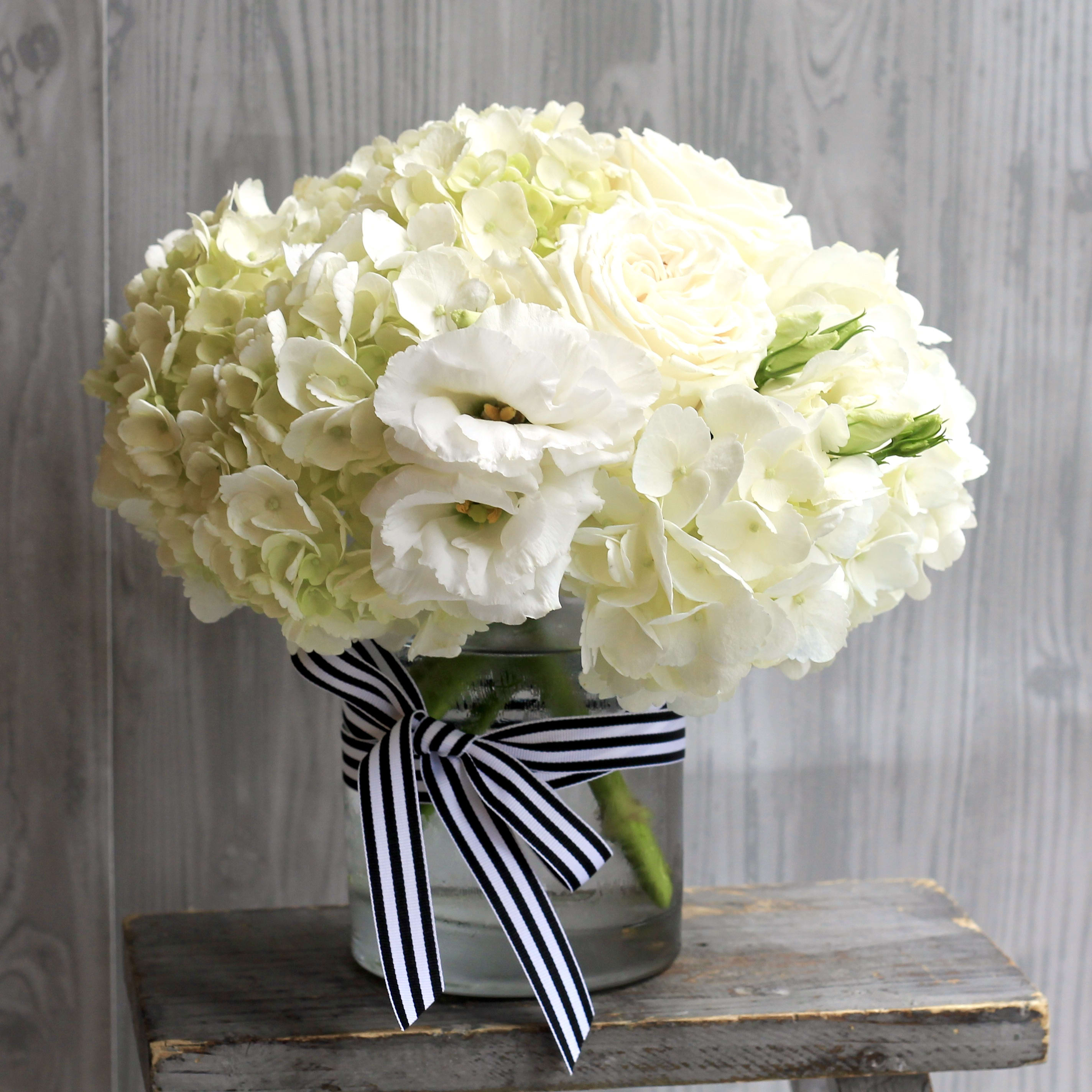 Sweet Darling - Cute 5 inch glass vase with white hydrangea, roses, carnation and other white flowers. Wrapped with ribbon. **NO SUBSTITUTIONS OR SPECIAL REQUESTS FOR THIS DESIGN**