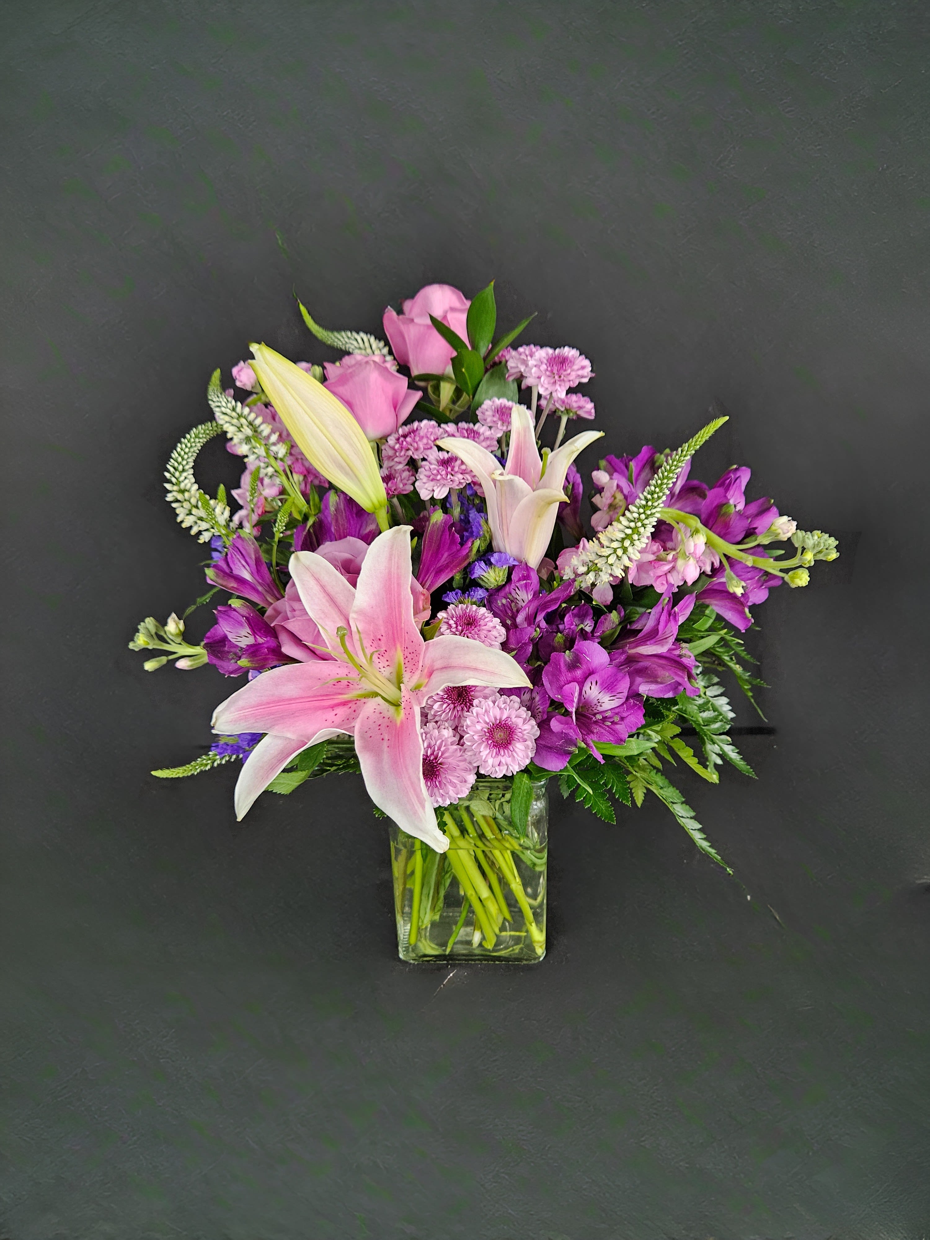Starstruck - Grab their attention and make them starstruck with this breathtaking arrangement center around beautiful and fragrant stargazer lilies. Also includes purple roses, lavender stock, purple button poms, purple alstro, and white veronica.