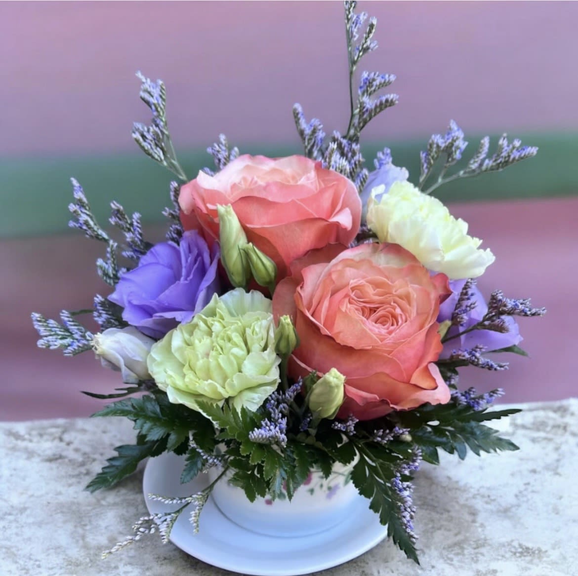 Peaches And Cream Coffee Cup - This arrangement has roses , limonium , lisianthus, carnations and greenery.