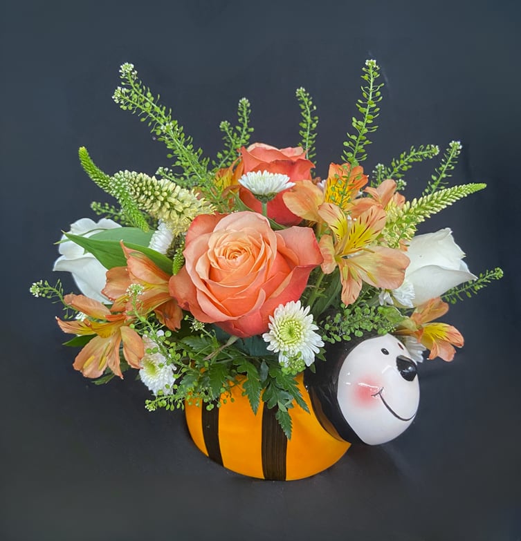 Bee Buddy - You've got a friend in Bee! The best friend to our Lovely Little Ladybug arrangement, this Bee Buddy is a bounty of beautiful garden flowers including Roses, Veronica, Button Poms, and Alstroemeria accented with Lepidium. What a better way to send summer smiles than in this keepsake bee planter!
